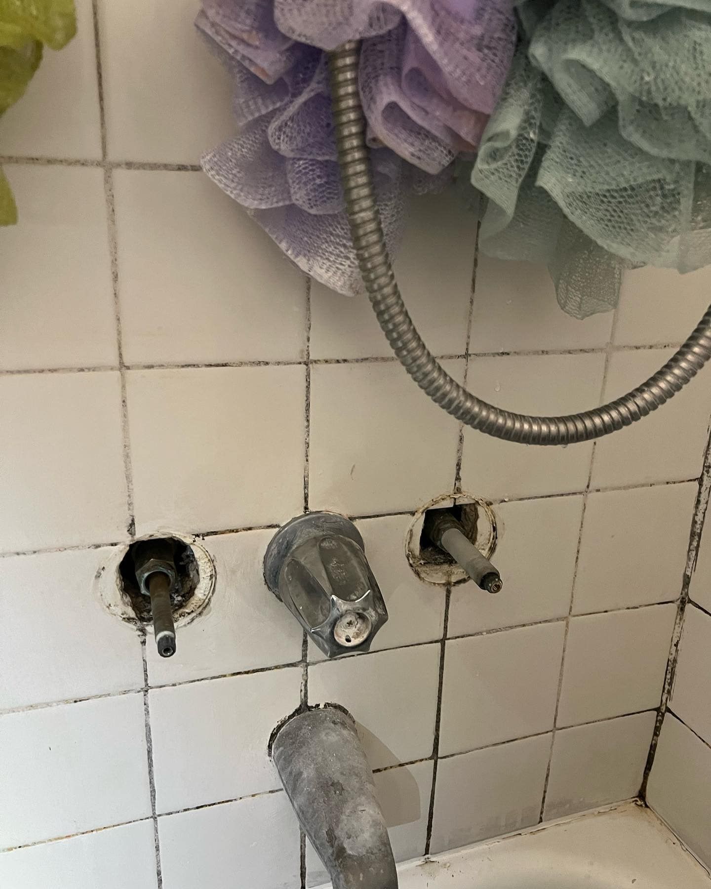 A bathroom with a bathtub and a shower head