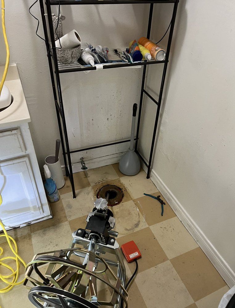 A bathroom with a sink , a shelf , and a drain open.