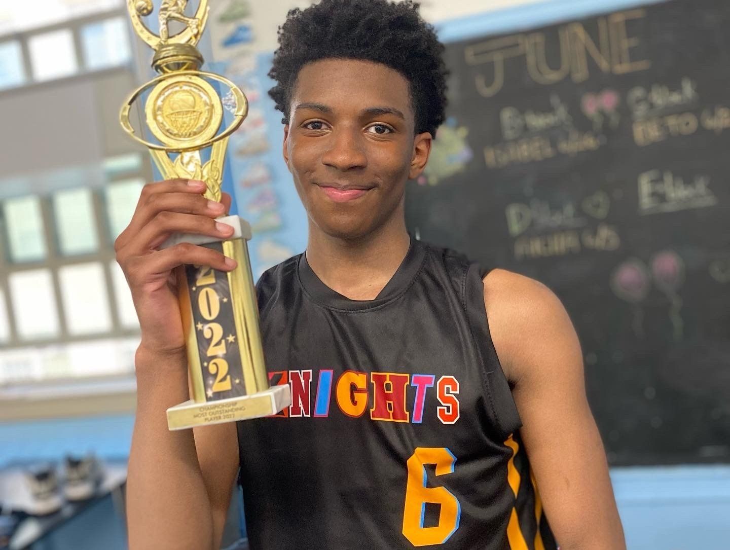 New Design Knights Team member poses with 2022 trophy