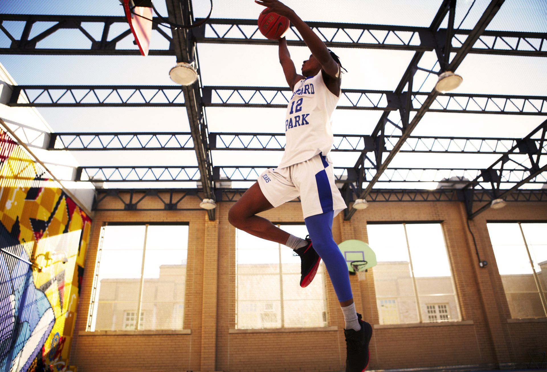 Member of the varsity Seward Park Campus Team plays basketball