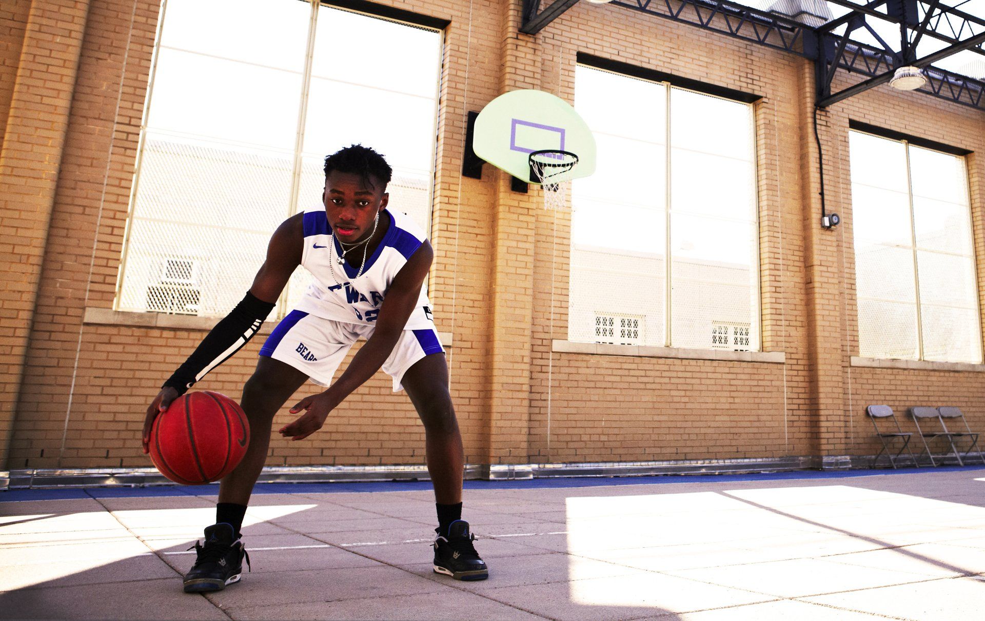 Member of the varsity Seward Park Campus Team, The Bears, dribbles