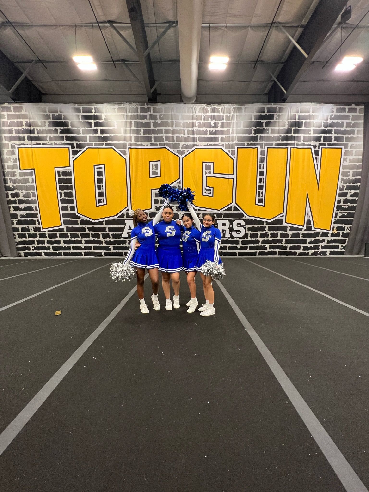 Cheerleaders pose at Top Gun gym