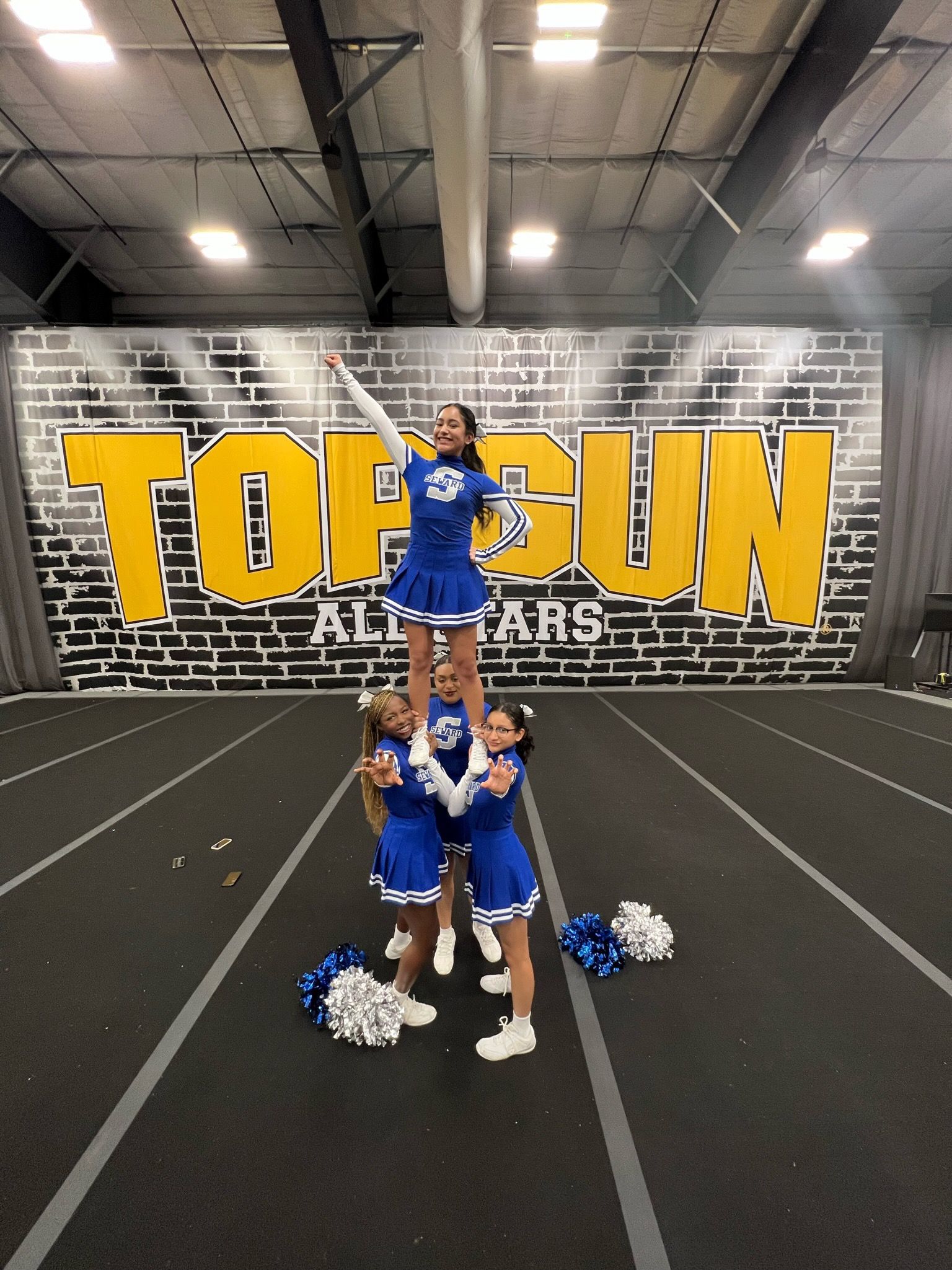 Cheerleaders doing pyramid stunt
