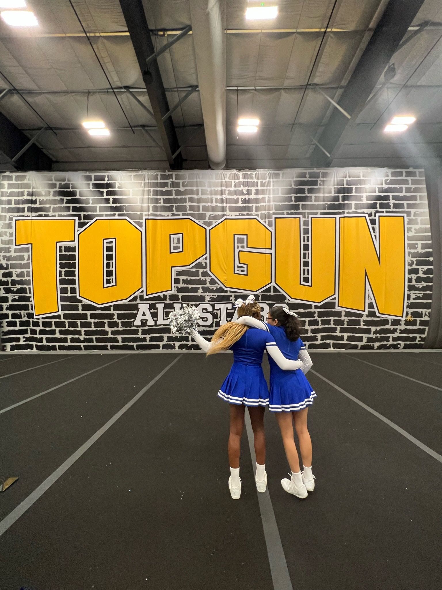 Cheerleaders pose at Top Gun gym