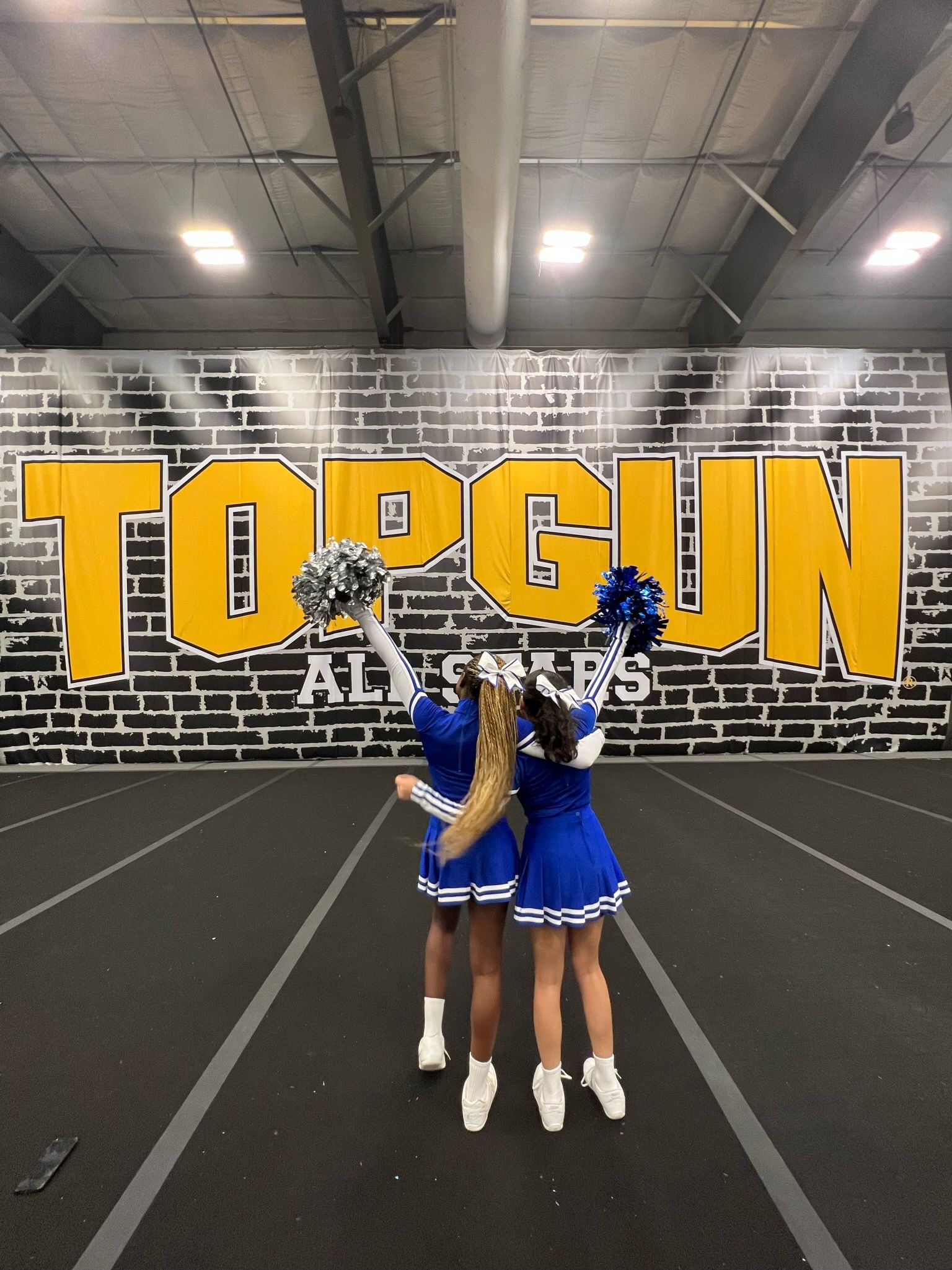 Cheerleaders pose at Top Gun gym