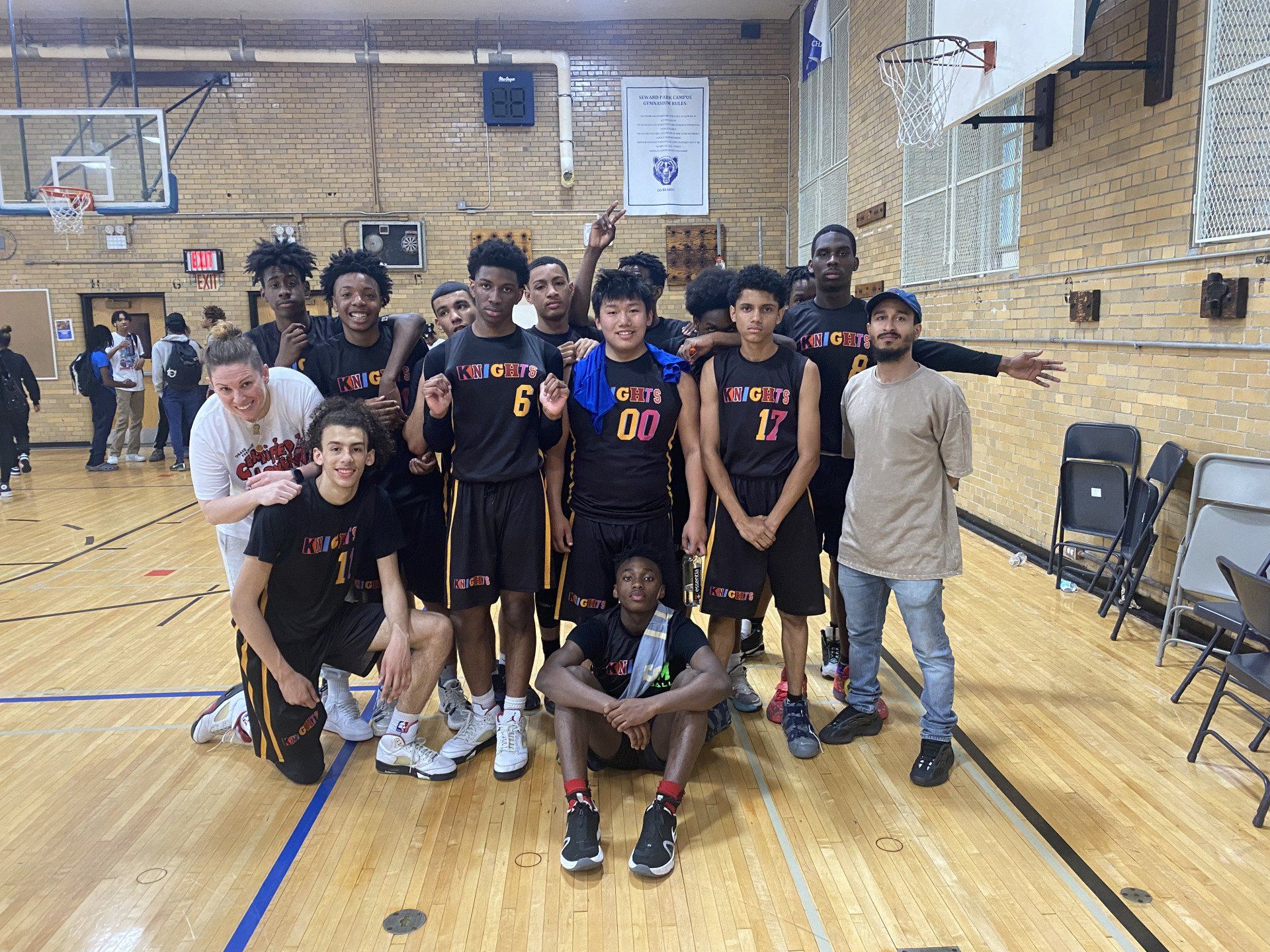 Members of the New Design Knights basketball team and their coaches