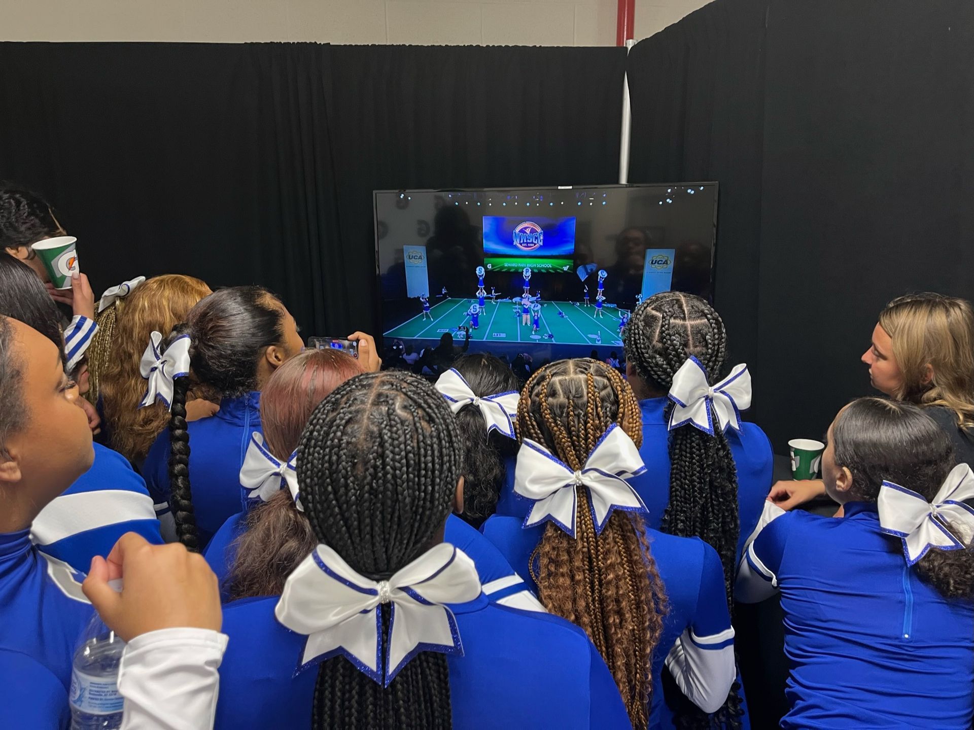 Cheerleaders watch playback at Nationals Competition 2022