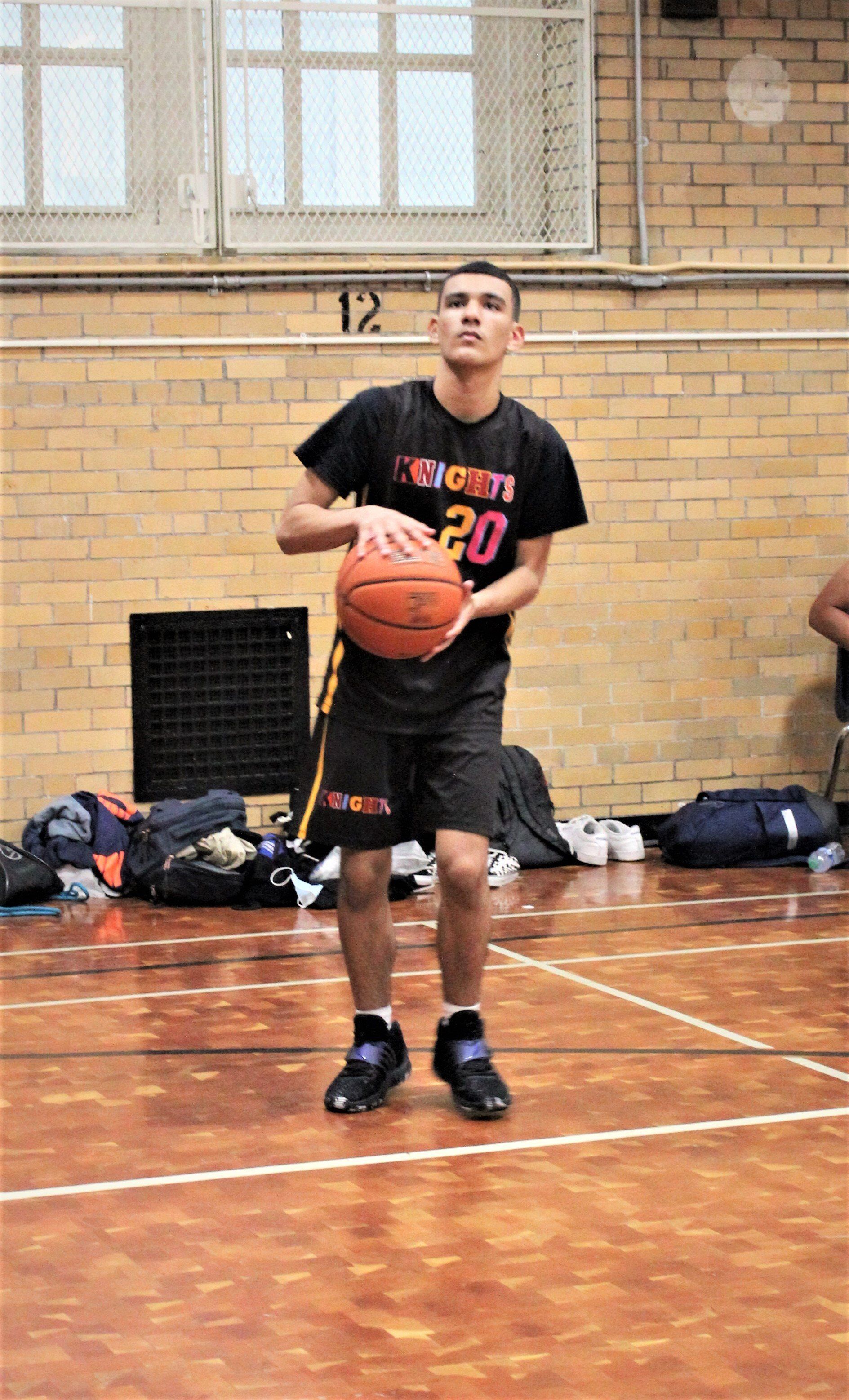 Member of the New Design Knights plays basketball