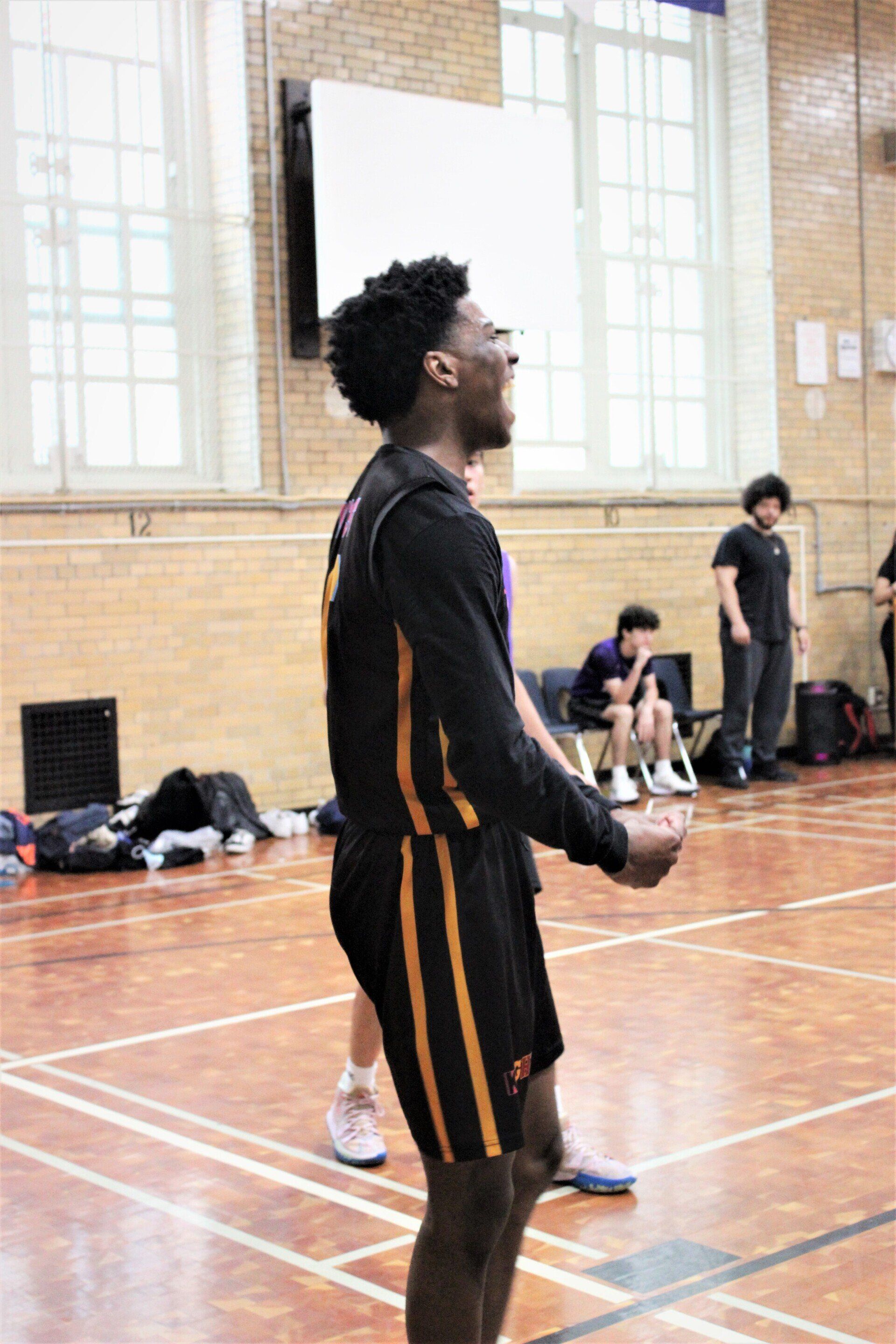 Members of the New Design Knights play basketball