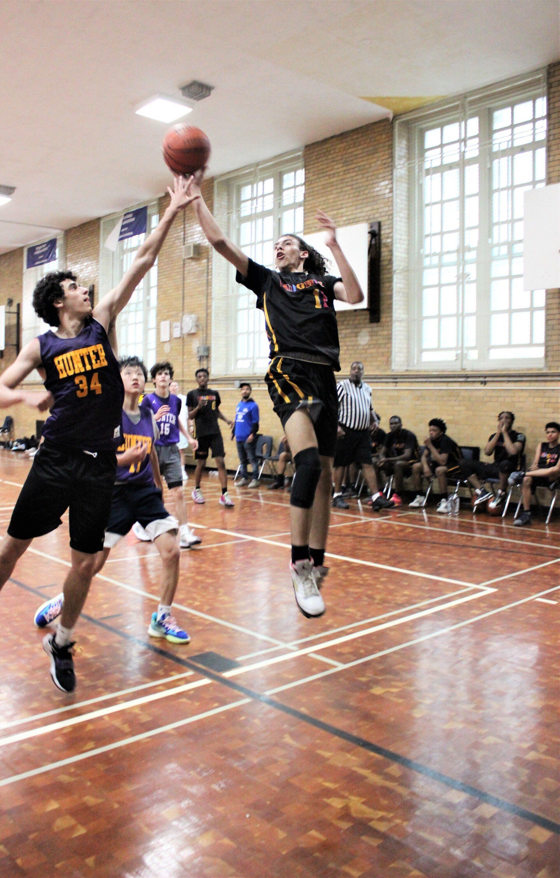 Members of the New Design Knights play basketball