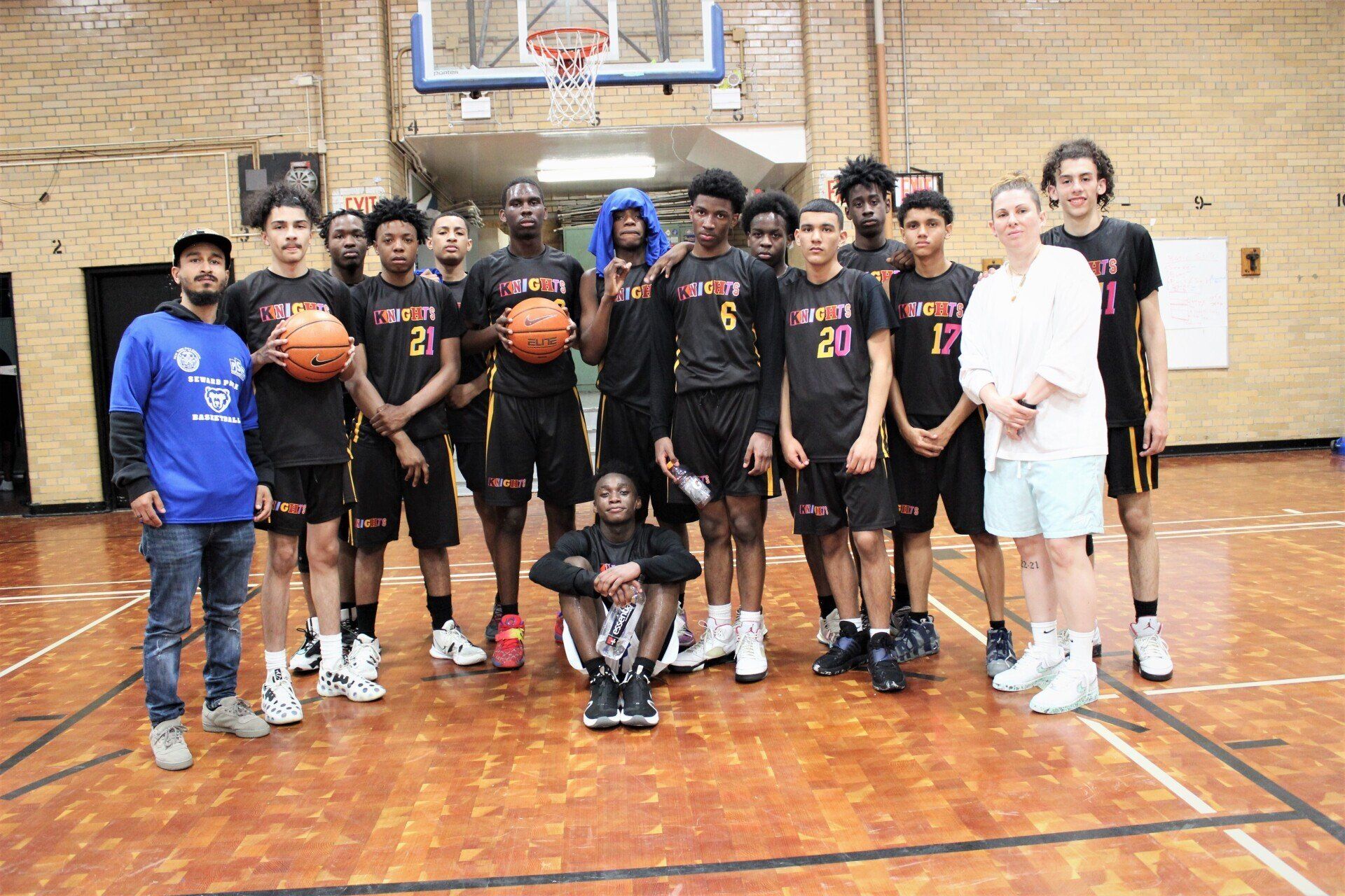 Members of the New Design Knights pose in their team uniform alongside Coach Katey