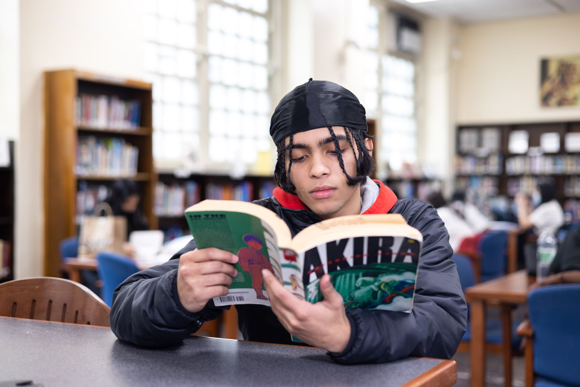 A student reading a book in the library