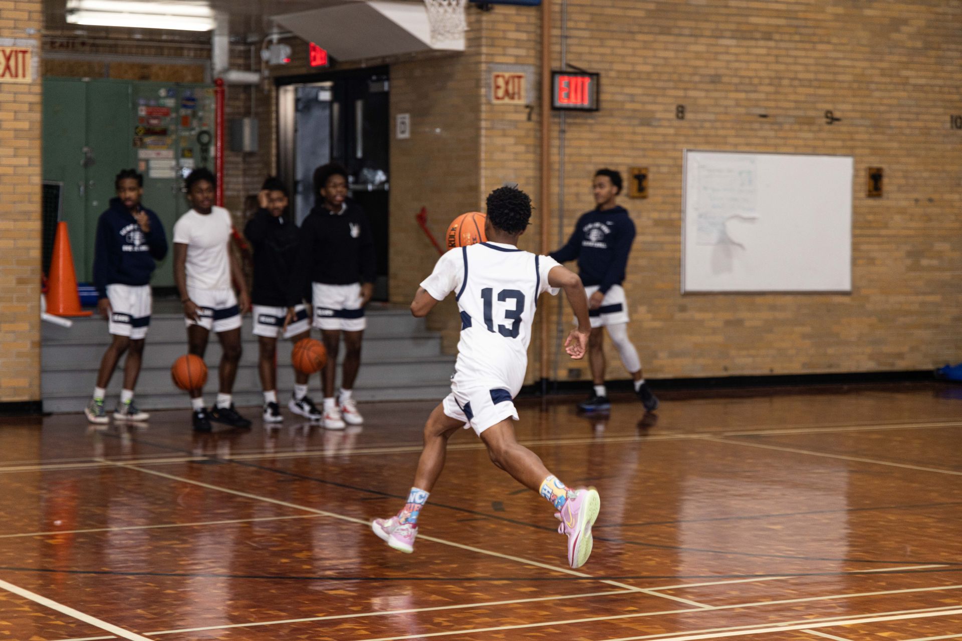 Student basketball team warming up with drills