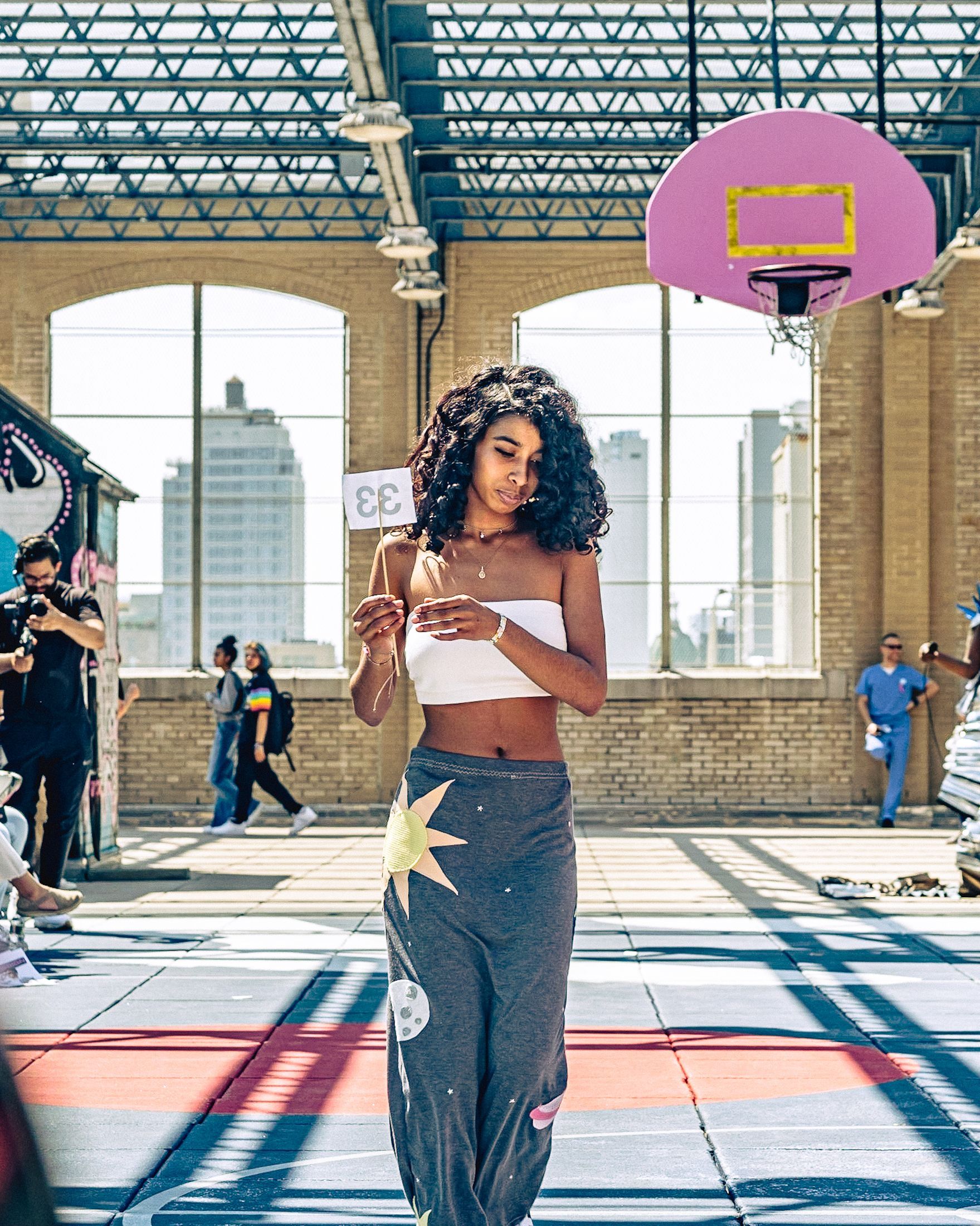 Model in hand-made garment at the 2023 Sustainable Fashion Show at New Design High School. Photo by Luis Suarez