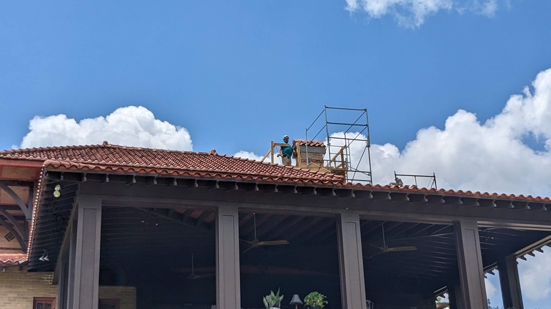 A man is working on the roof of a building.