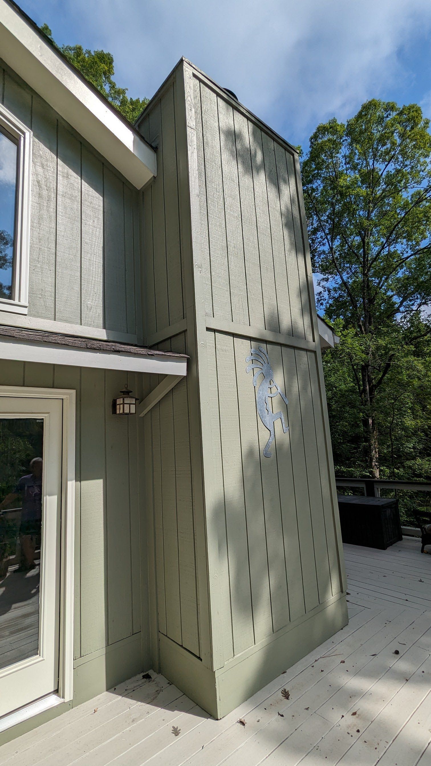 A climbing wall is attached to the side of a house.