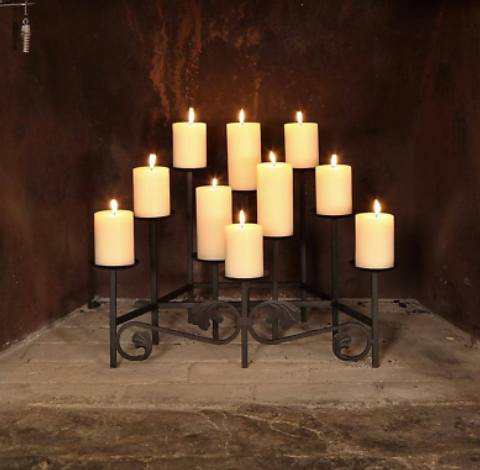 a bunch of candles are lit up in a fireplace