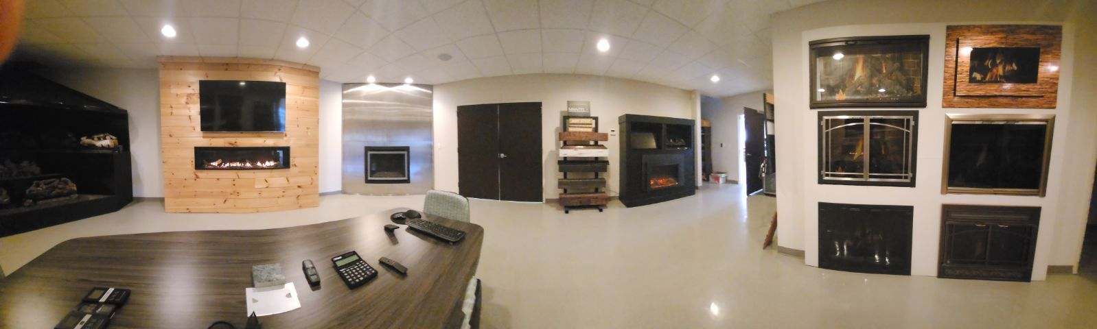 A large room with a lot of televisions on the wall.