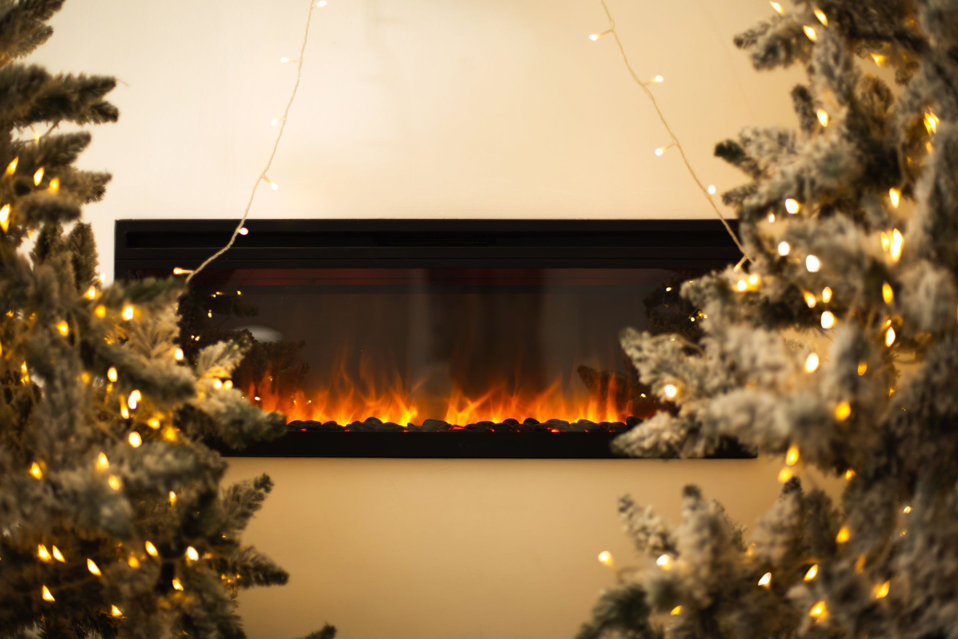 there is a fireplace with a christmas tree in the background .