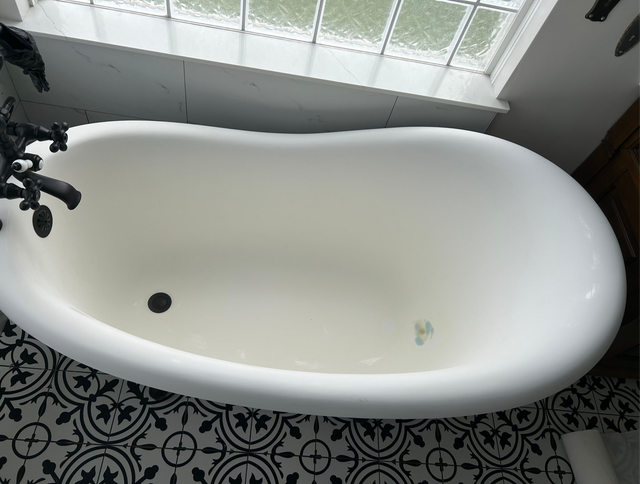 Happy homeowner with refinished bathtub