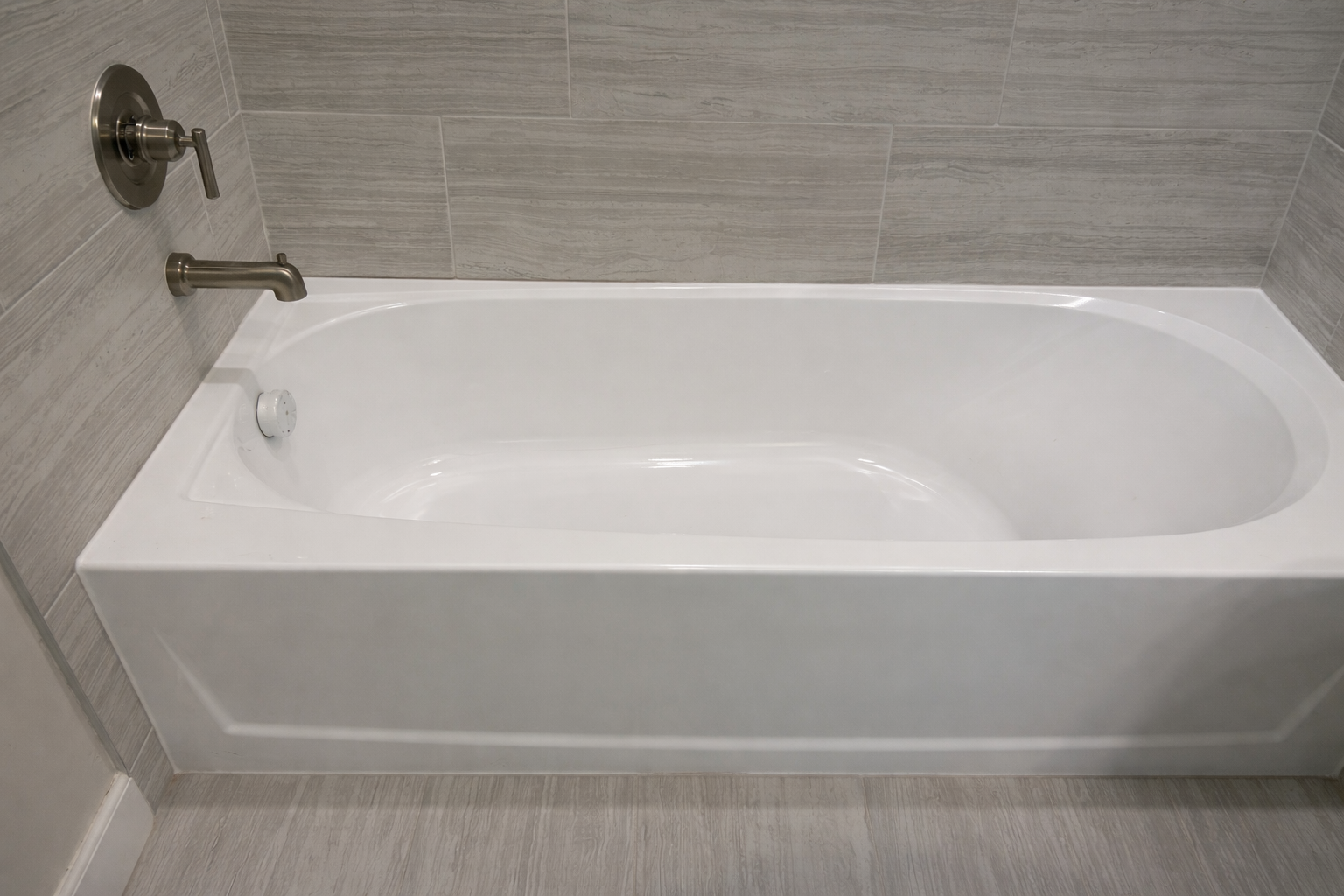 Stained and worn bathtub before professional refinishing