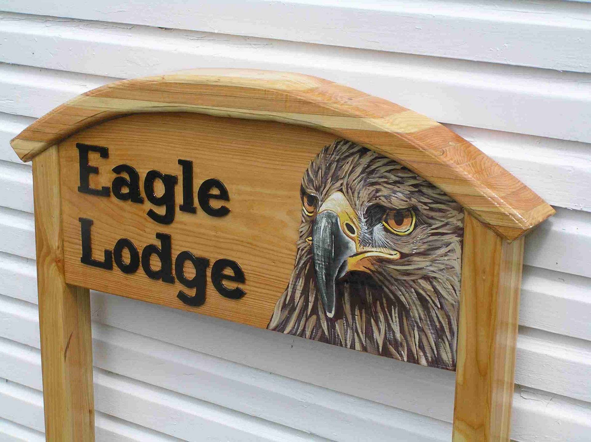 A wooden Scottish house sign with a hand painted picture of an eagle, by Ingrained Culture