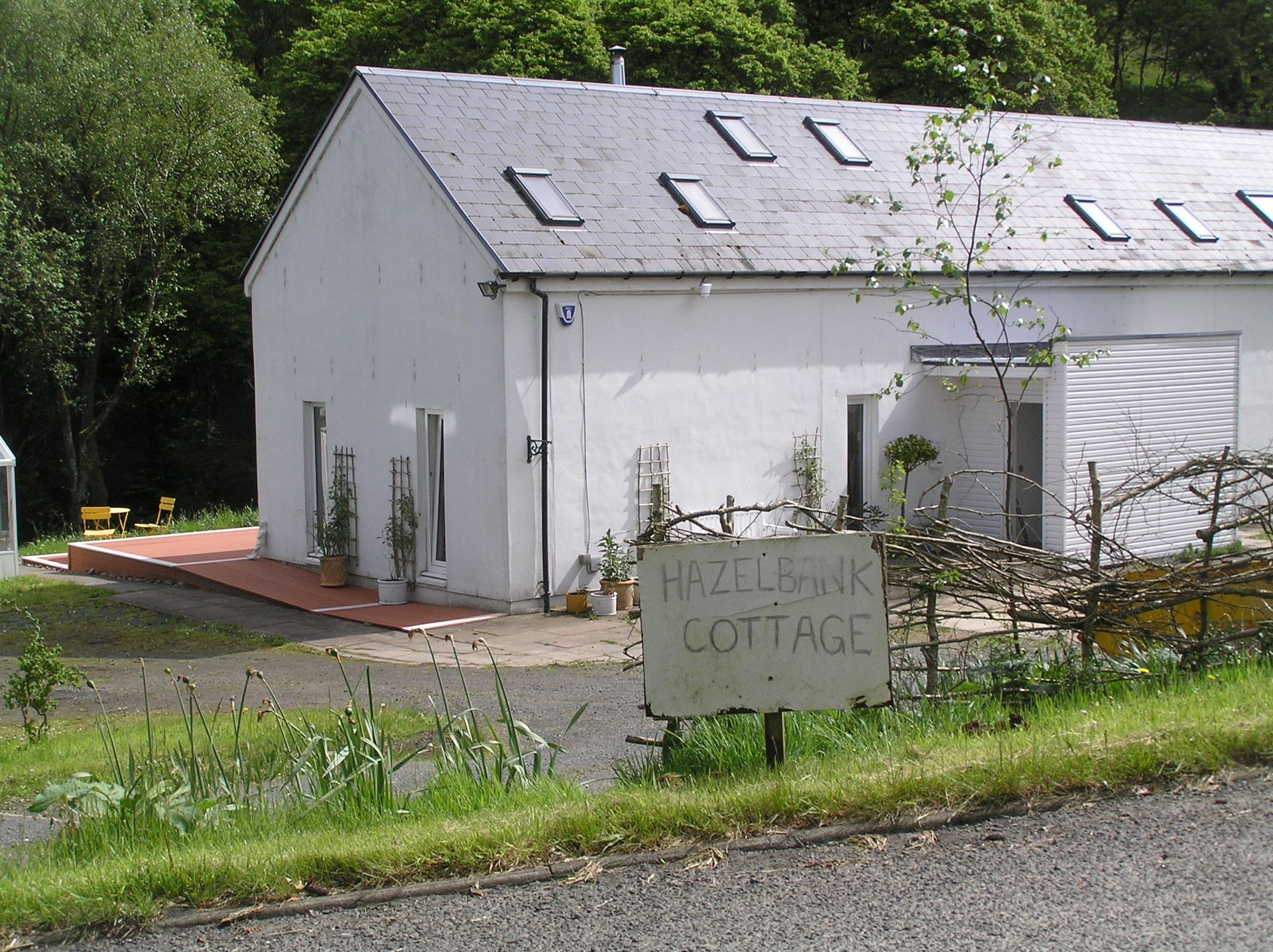 A picture of a house before a new house sign was installed made by Ingrained Culture