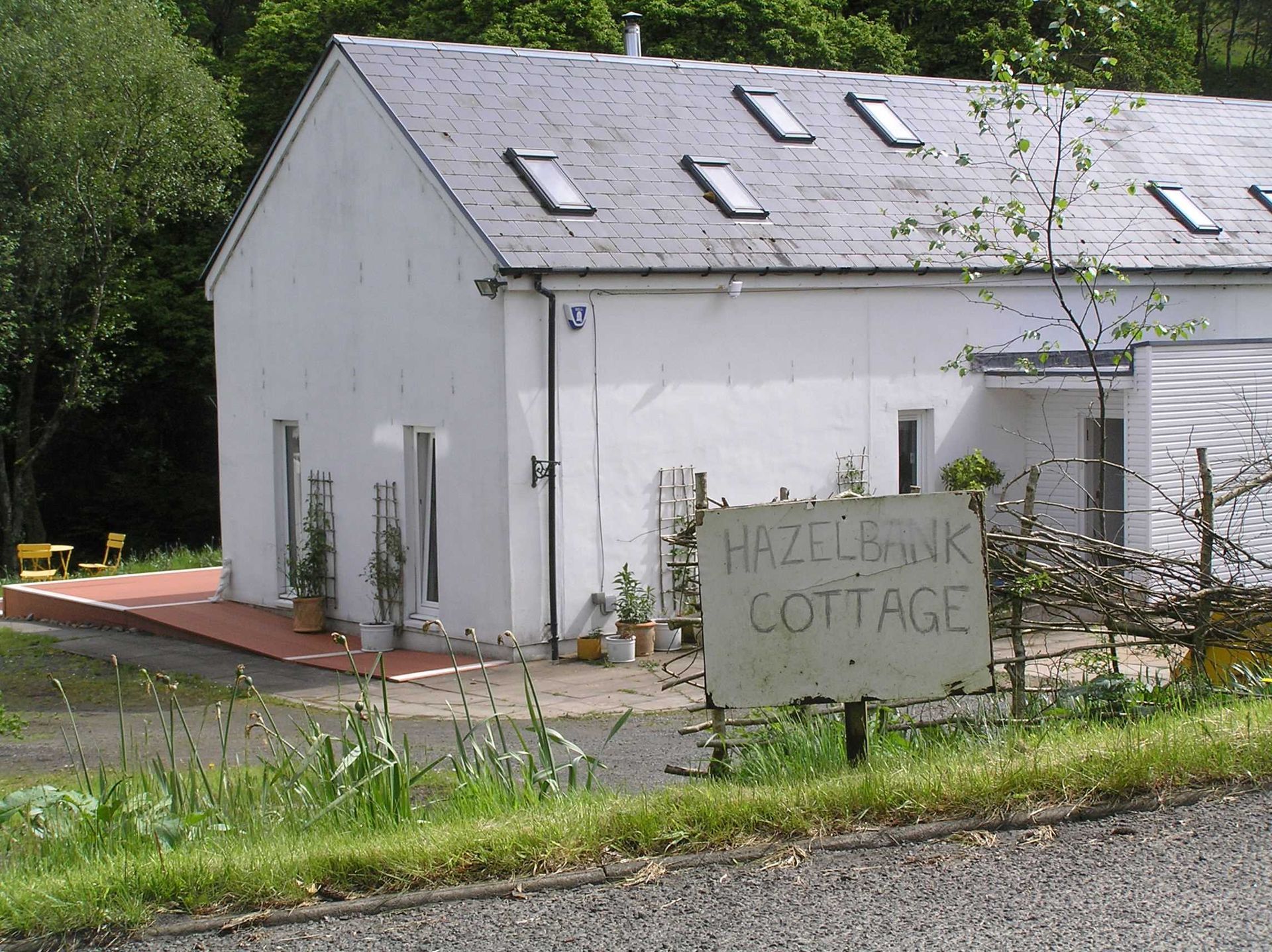 A picture of a house before a new house sign was installed made by Ingrained Culture