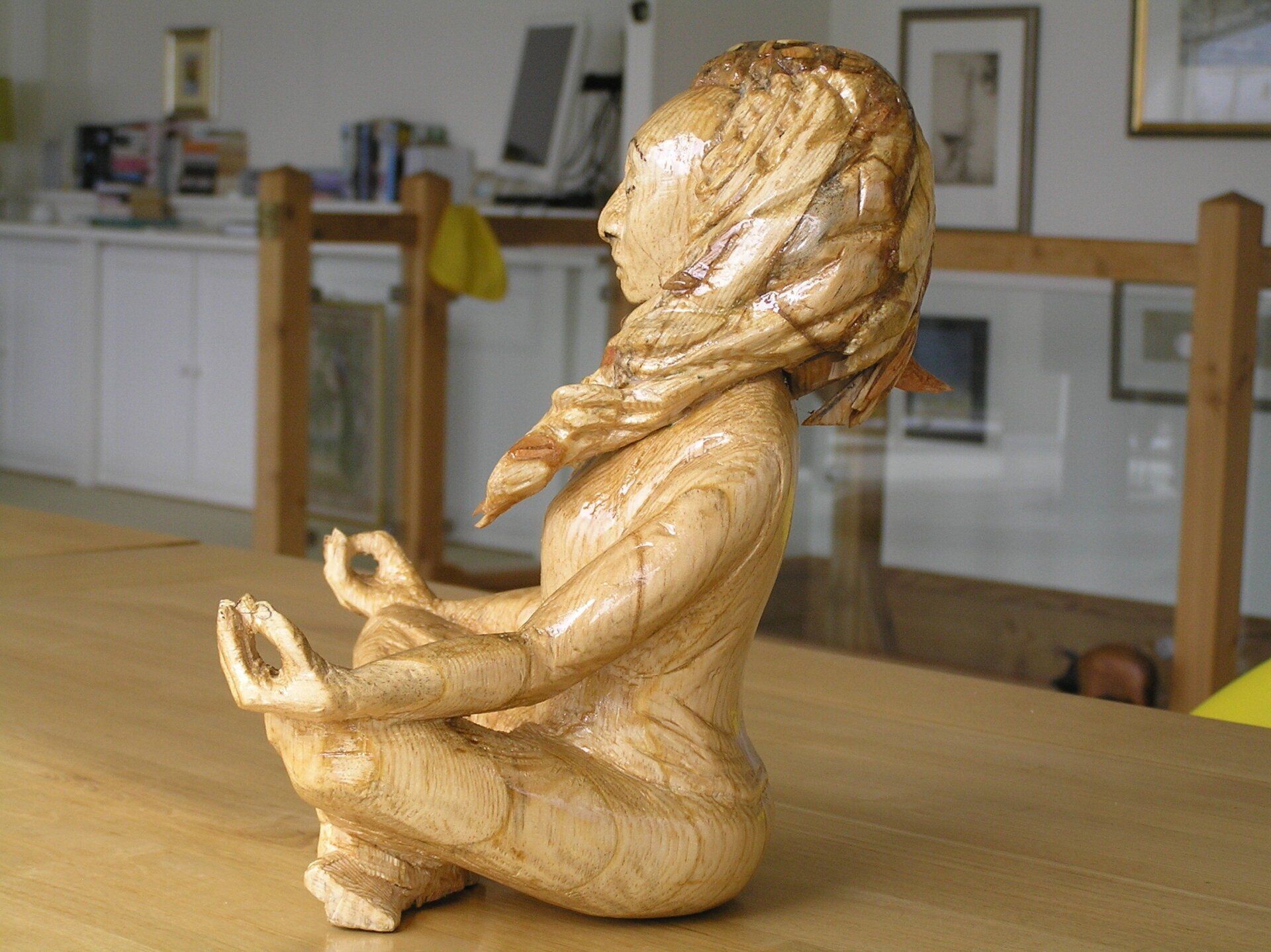 A small wooden figurative sculpture made from wood by Ingrained Culture.