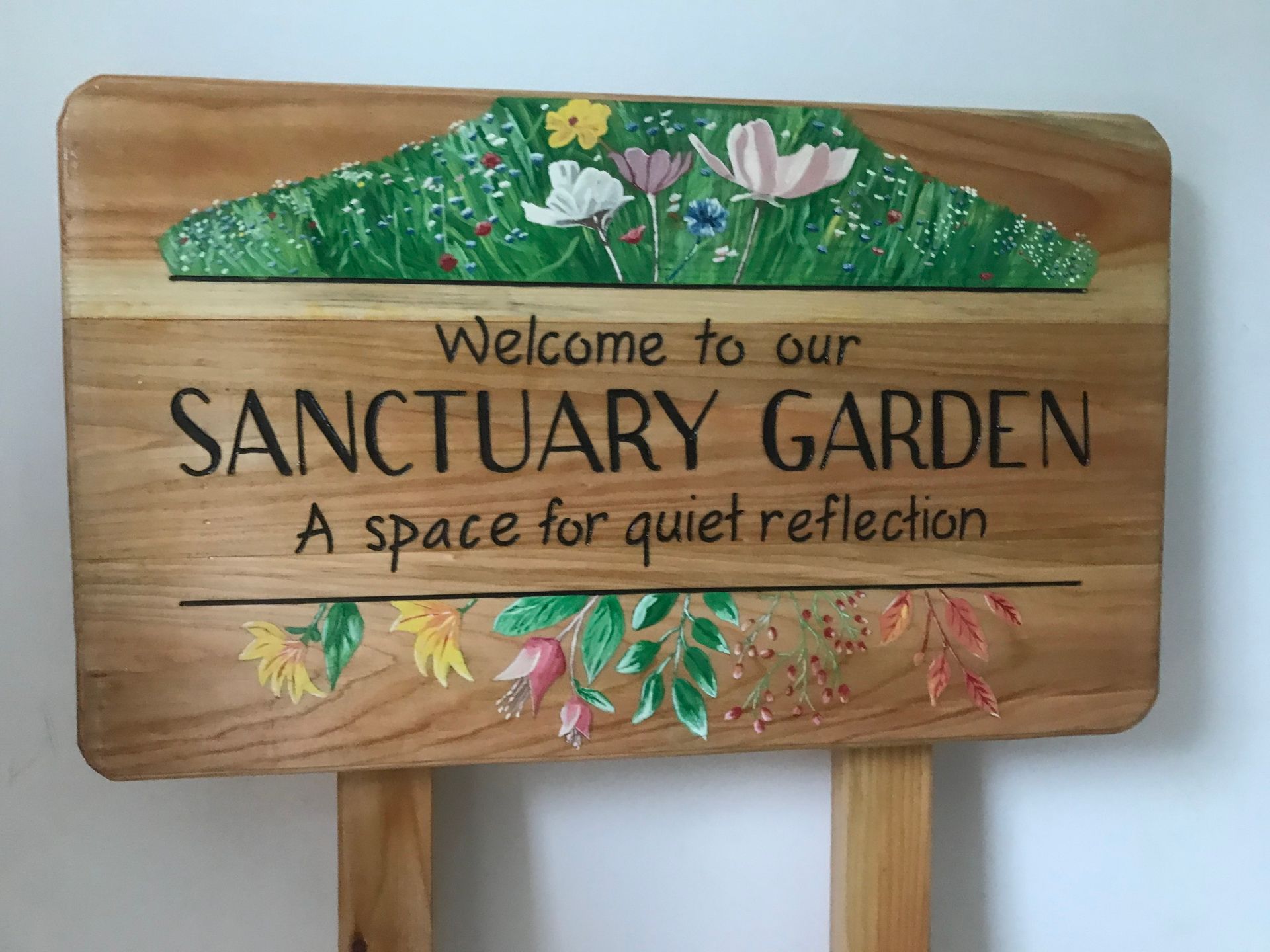 A public space memorial wooden sign, hand painted and sustainable, made in the UK by Ingrained Culture 
