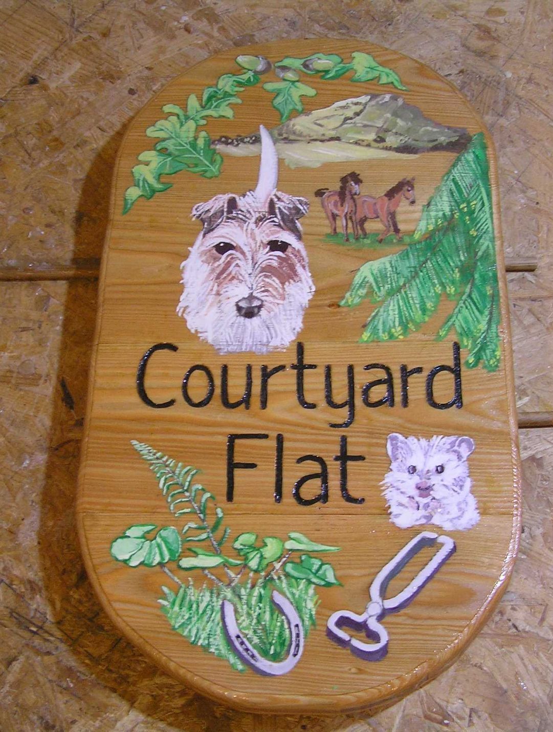 Personalised wooden house name sign illustrated with pet portraits made by Ingrained Culture