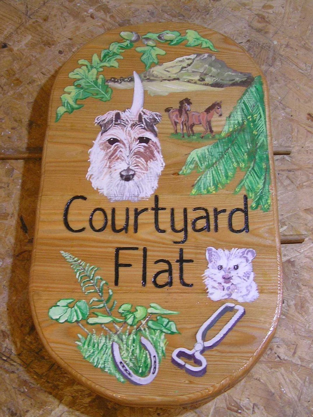 Personalised wooden house name sign illustrated with pet portraits made by Ingrained Culture