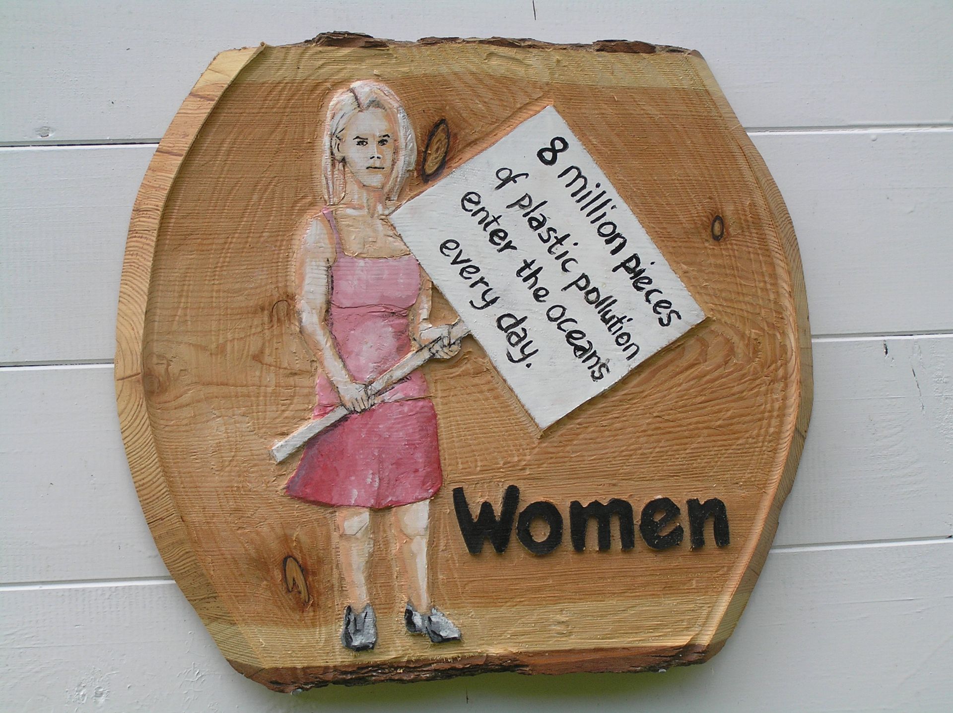 A wooden Eco-warrior female toilet sign made by Ingrained Culture