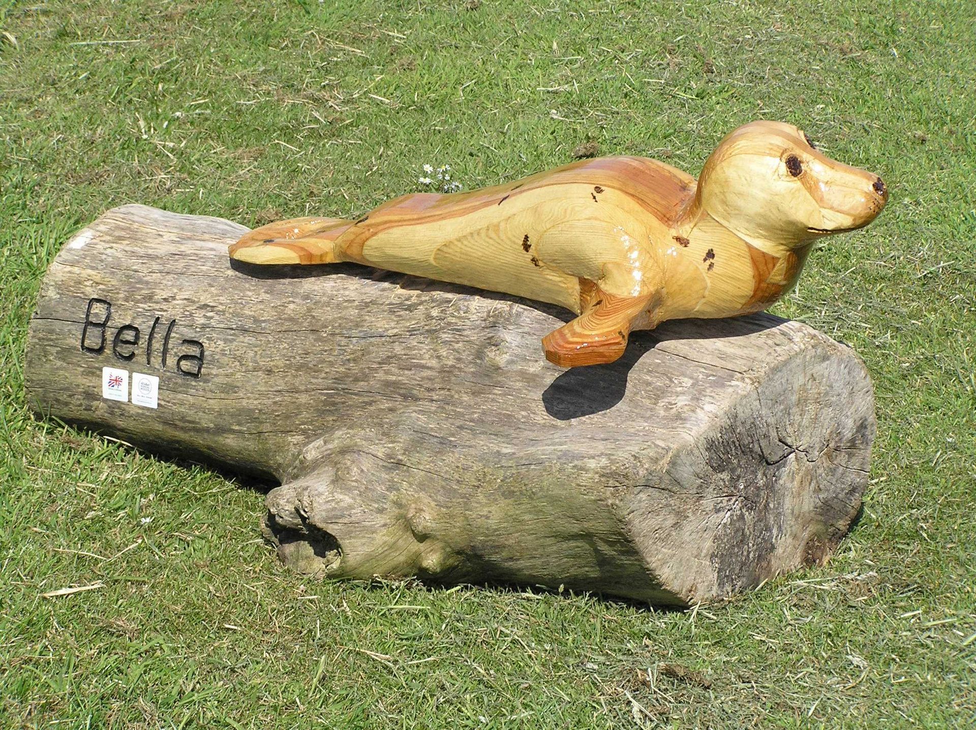 A wooden sculpture of a seal made by Ingrained Culture