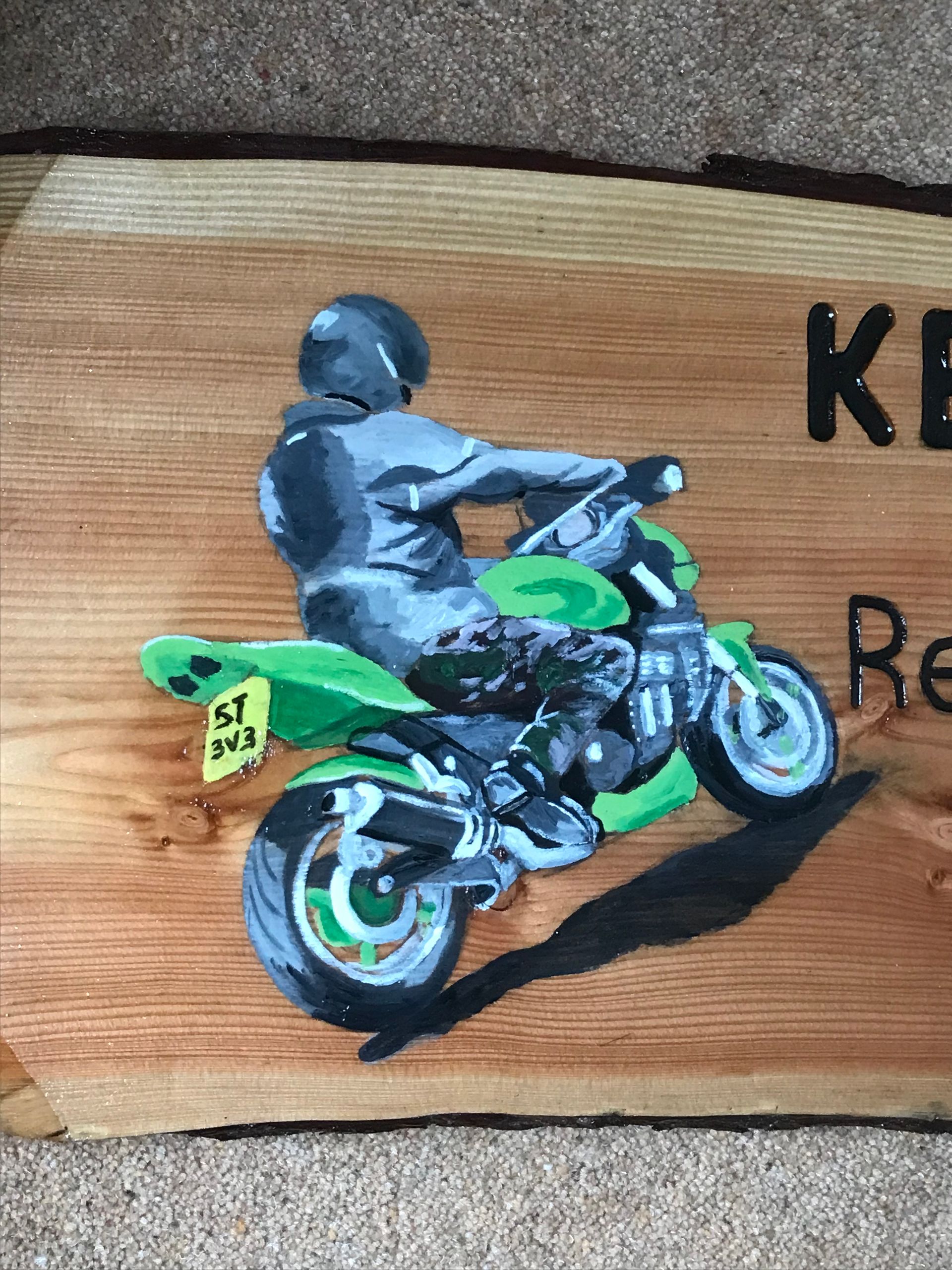 Hand painted illustration of a motor bike on a wooden sustainable UK sign made by Ingrained Culture