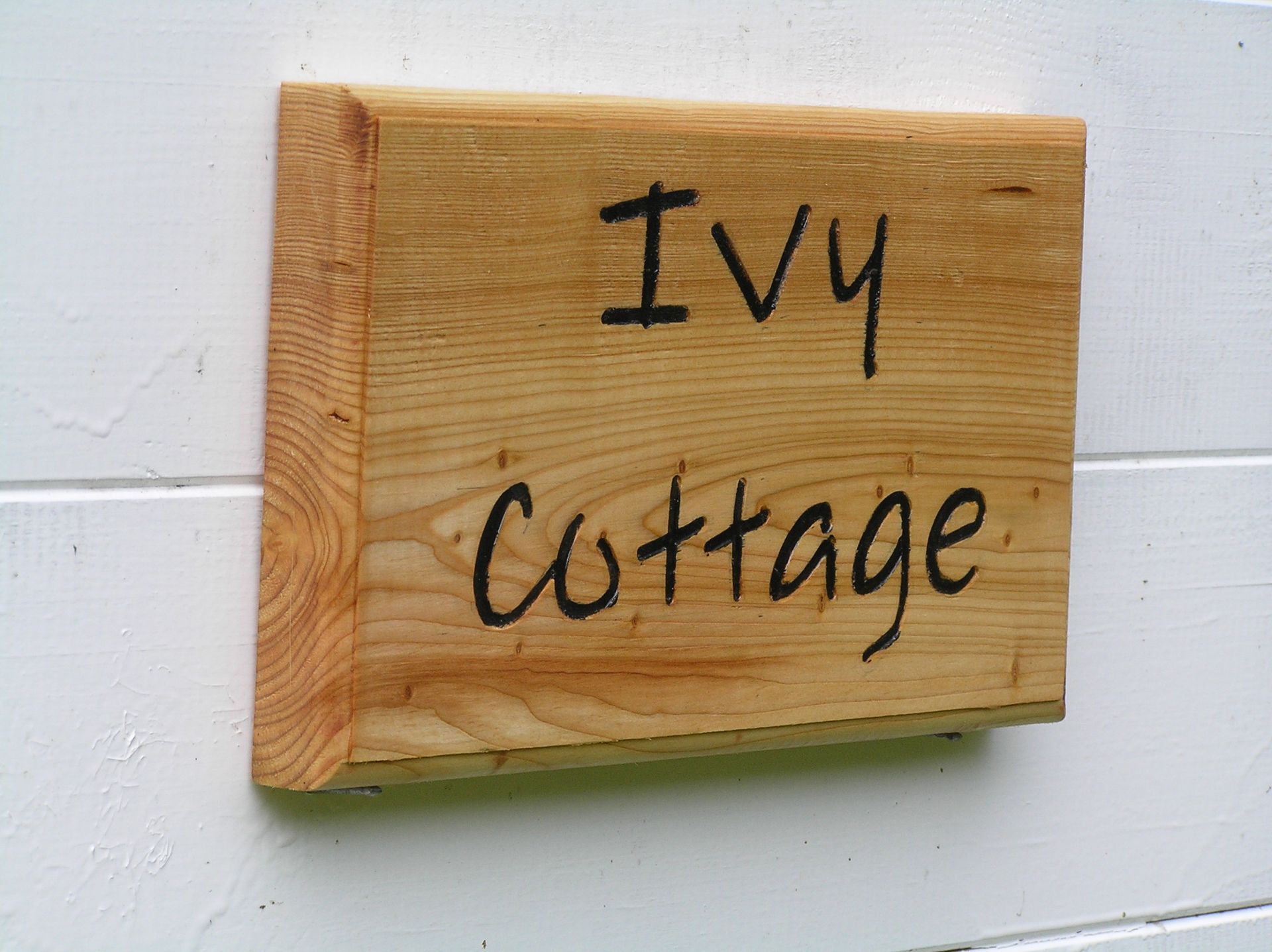 A contemporary wooden house name plate made by Ingrained Culture