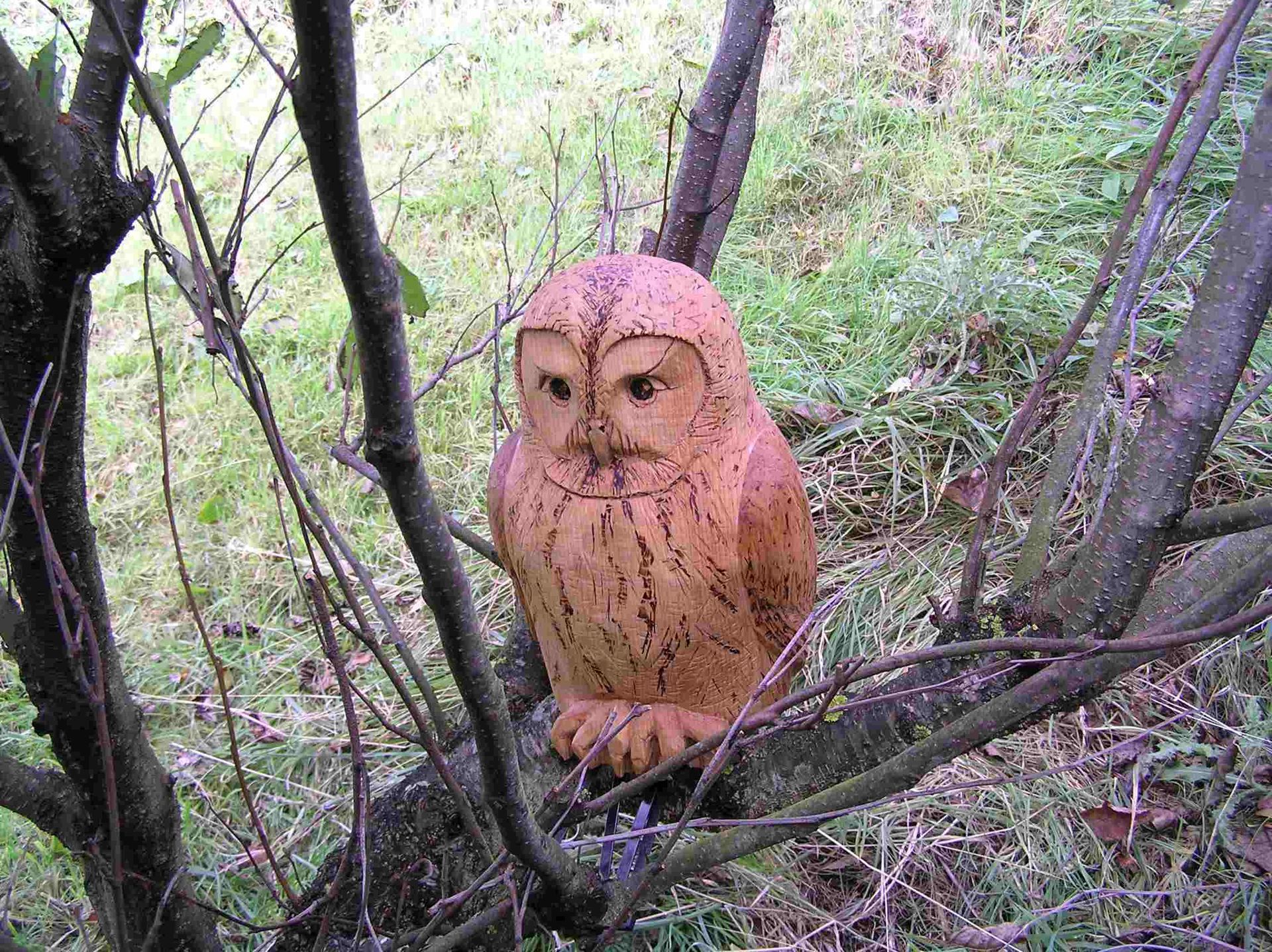 A wooden owl garden sculpture made by Ingrained Culture