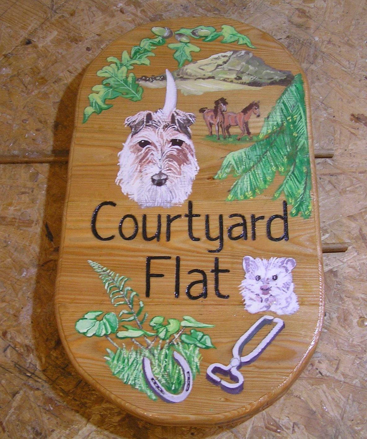 Personalised wooden house name sign illustrated with pet portraits made by Ingrained Culture