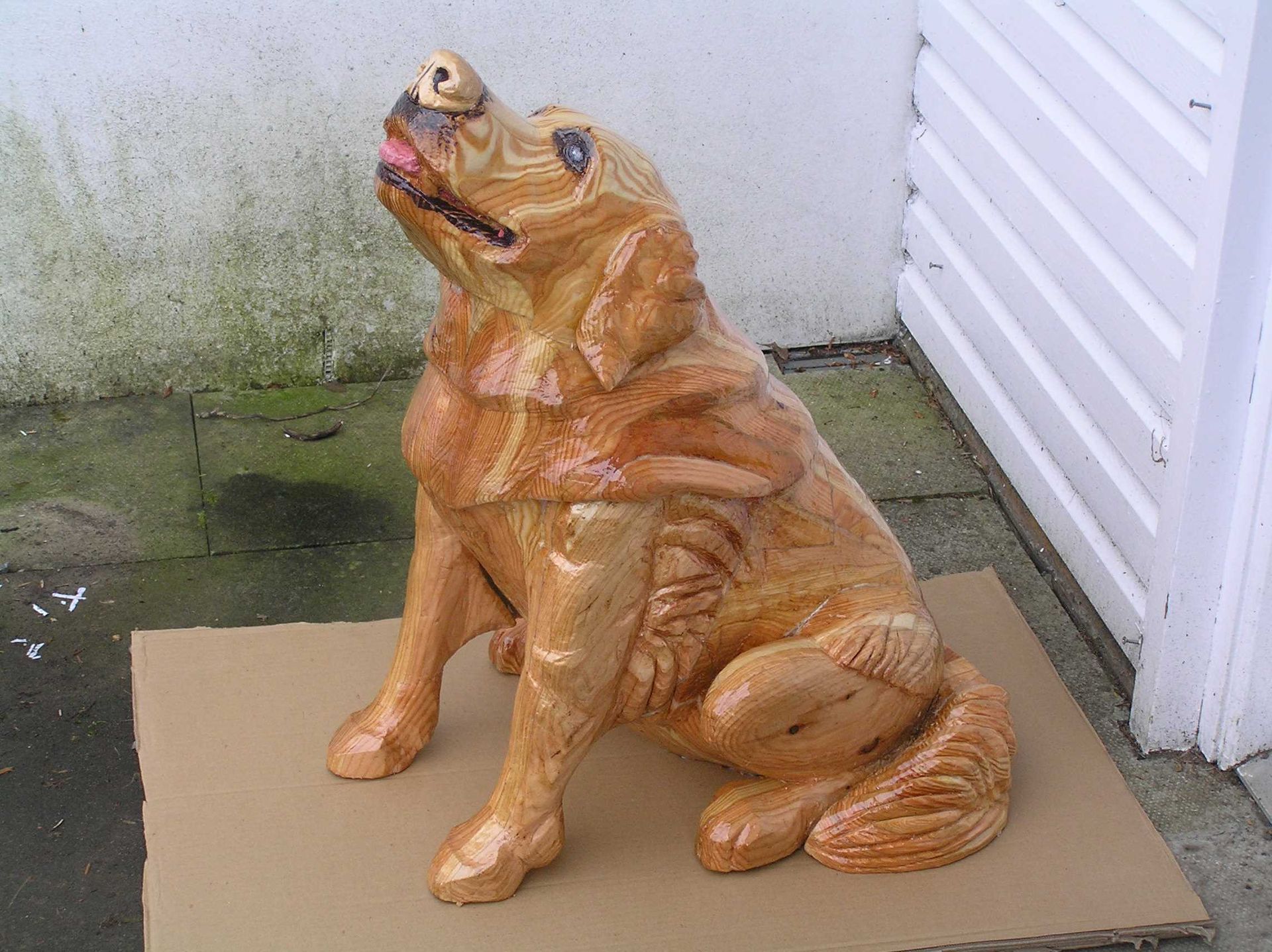 A wooden dog sculpture by Ingrained Culture