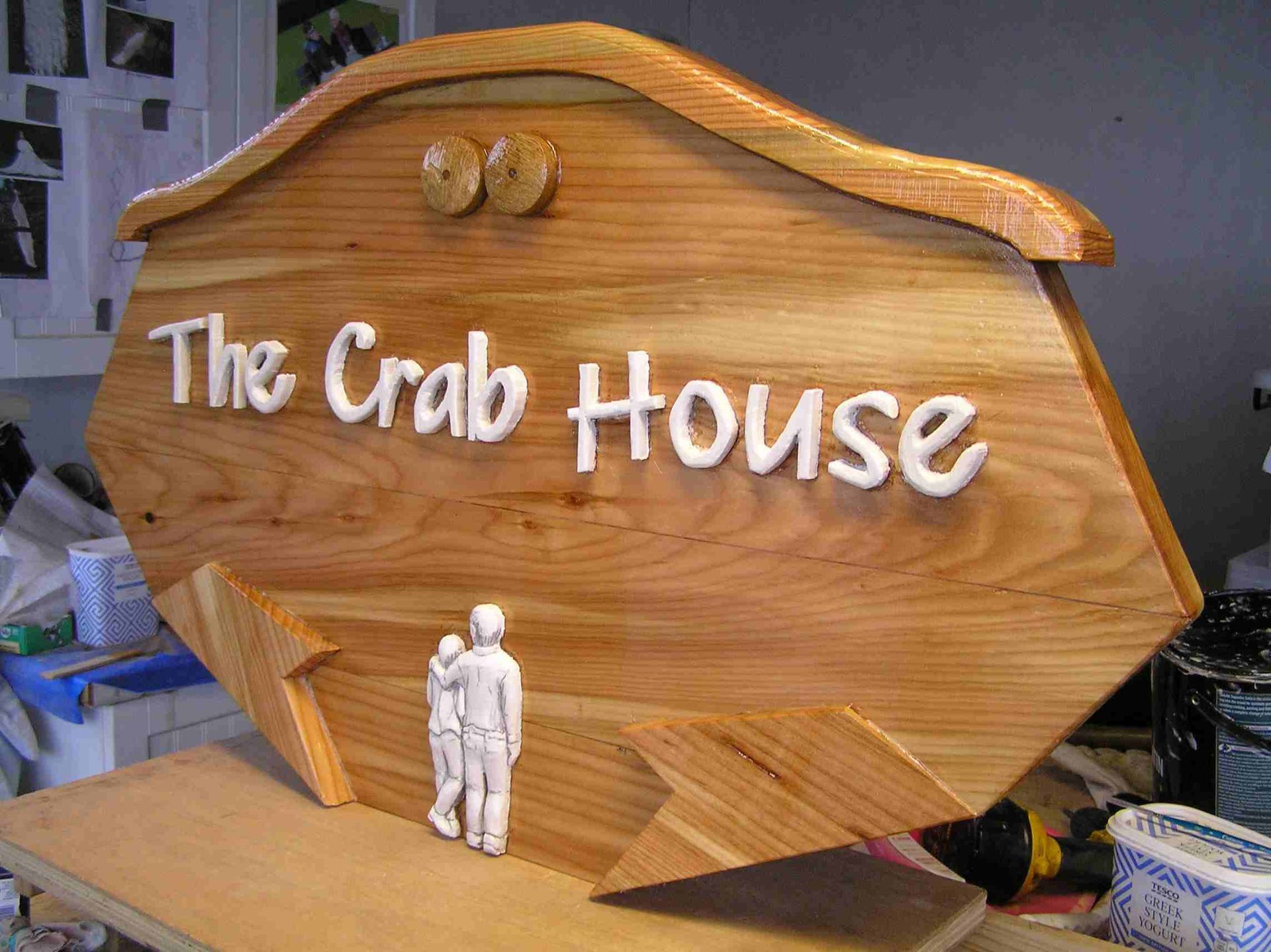 A wooden house sign designed professionally and by hand by Ingrained Culture