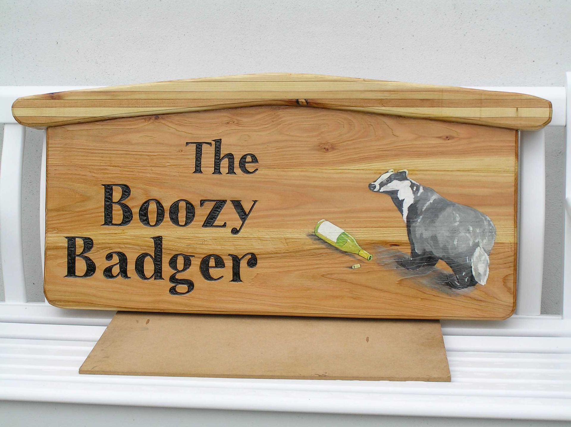 A wooden Pub sign handmade and hand painted by Ingrained Culture