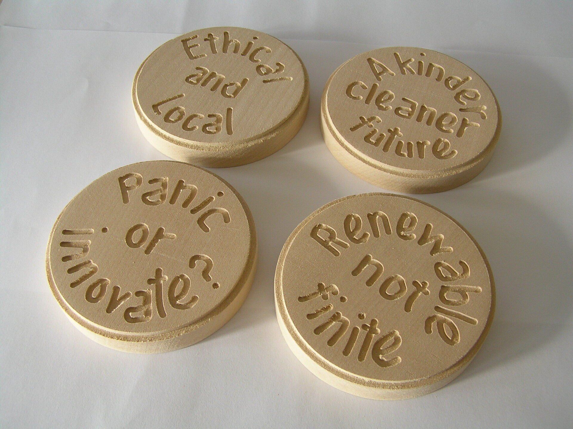 Set of four Climate Currency wooden coins.