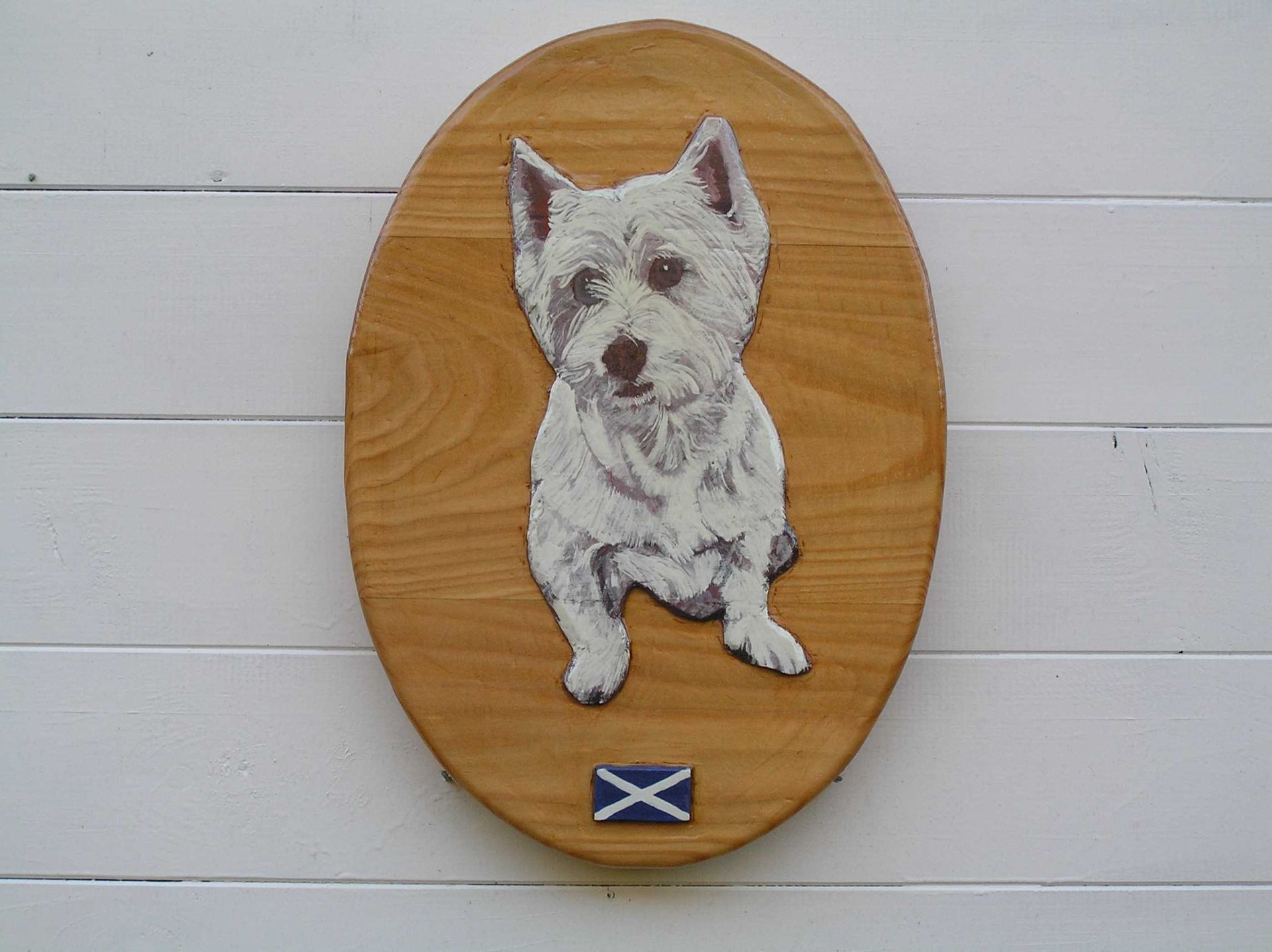 A front door plaque featuring a pet portrait of a westie dog made by Ingrained Culture