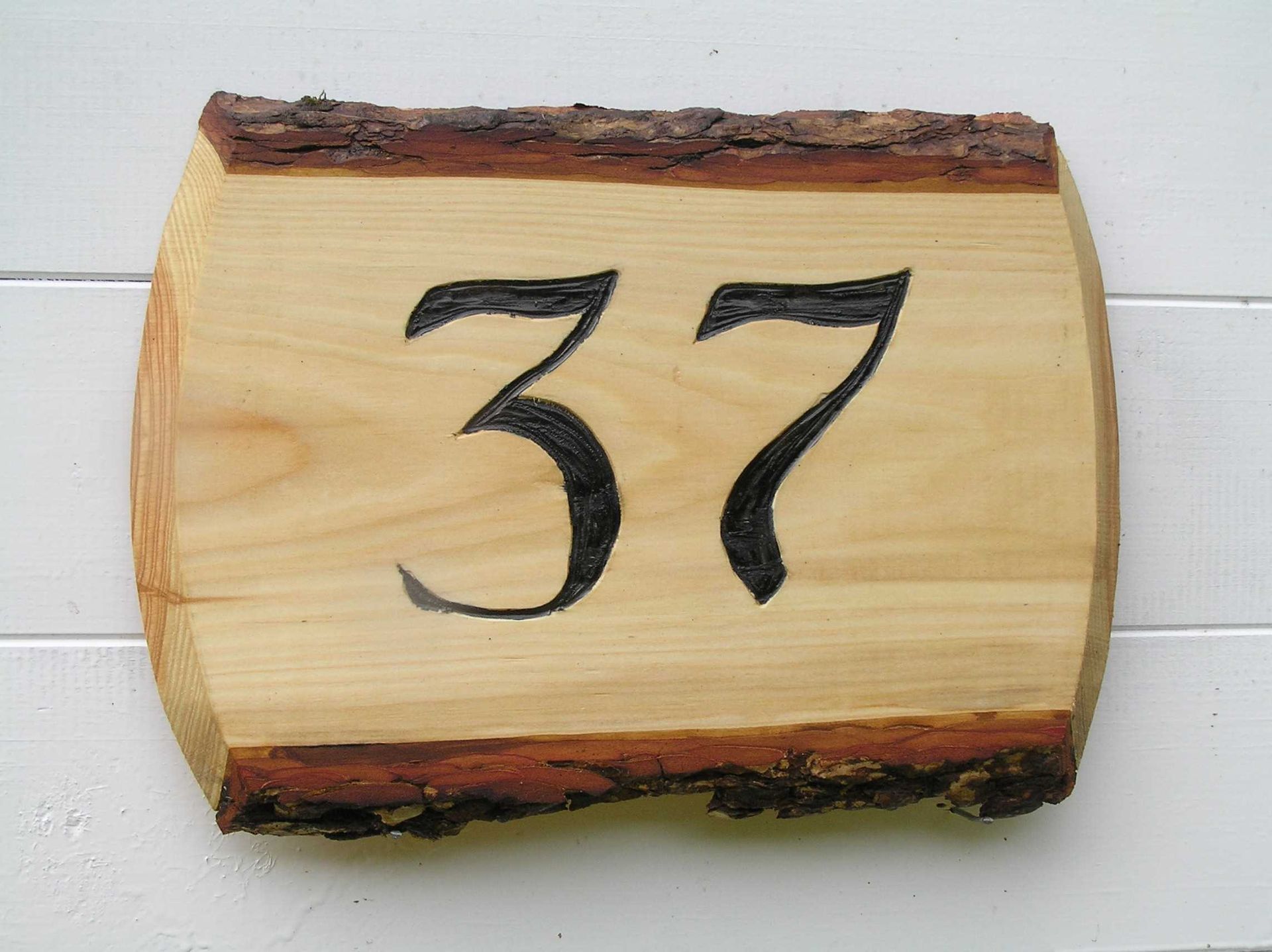 An on trend wooden house number plaque made by Ingrained Culture