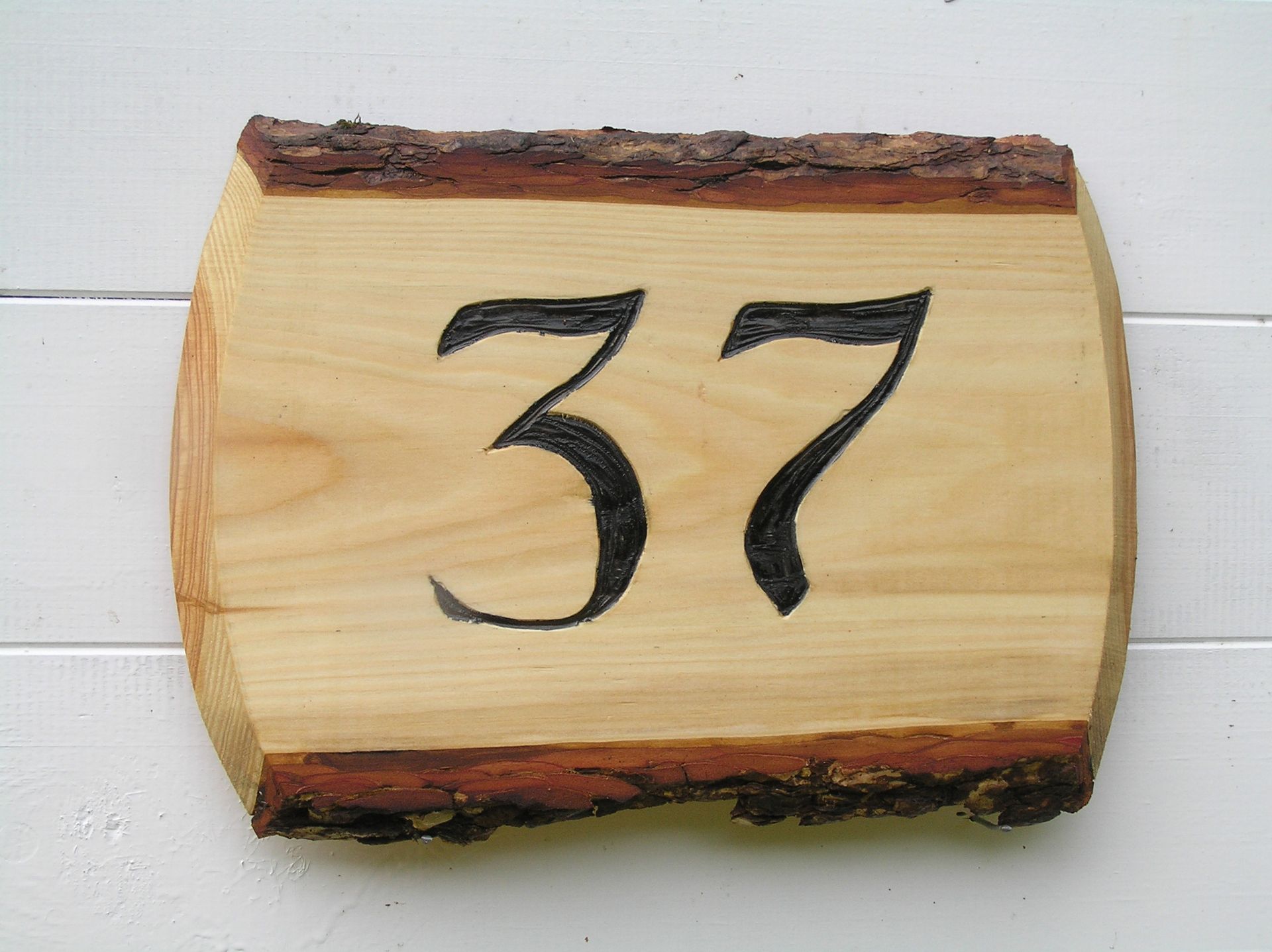 A wooden house number plaque by Ingrained Culture