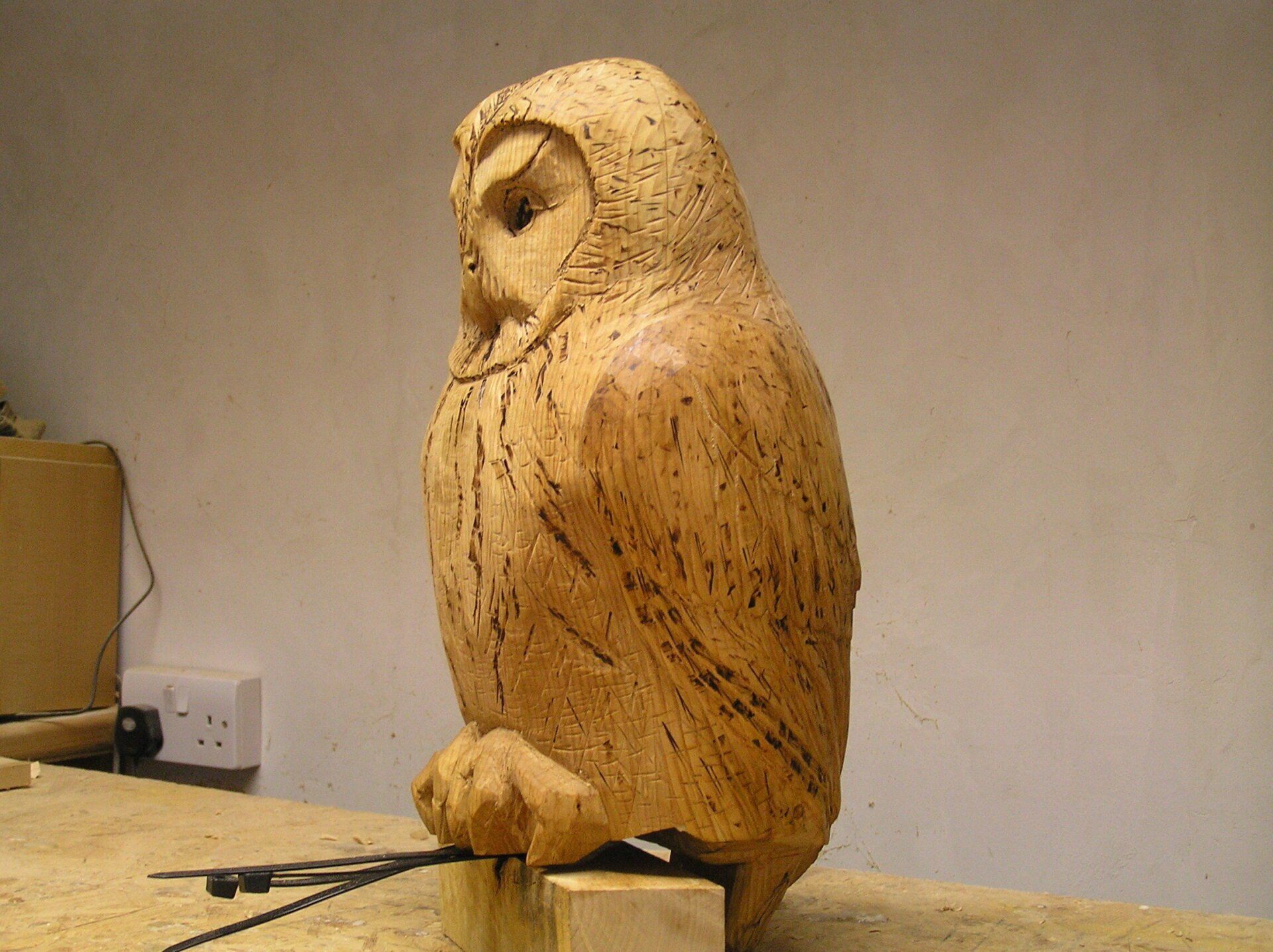 A wooden owl sculpture made by Ingrained Culture