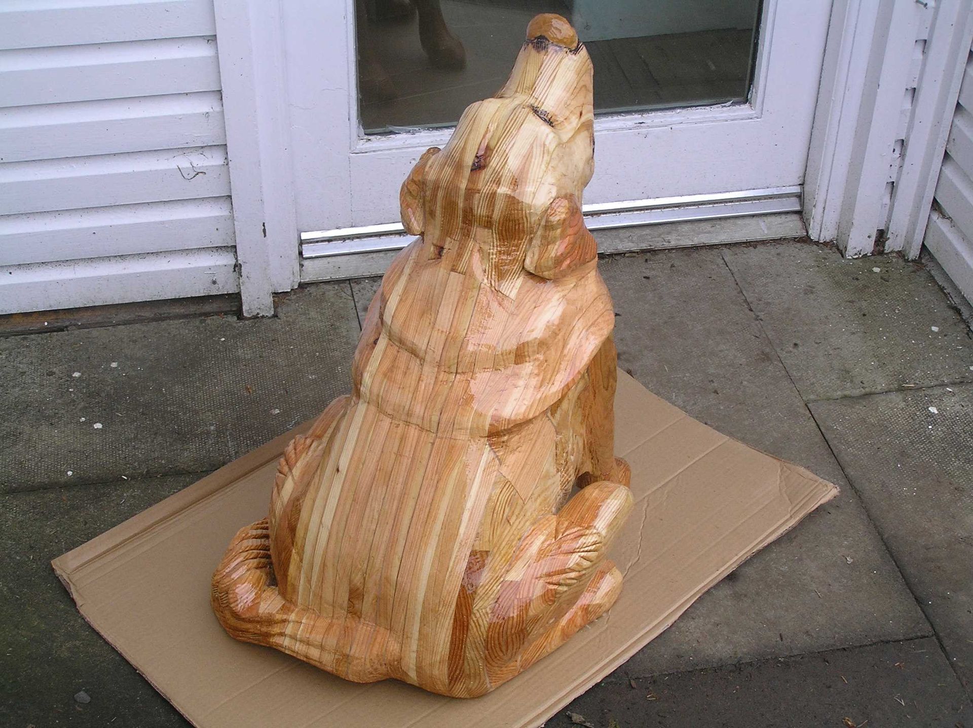 rear view of a wooden dog garden sculpture by Ingrained Culture