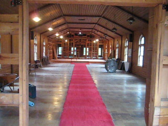 a long room with a red carpet going through it.