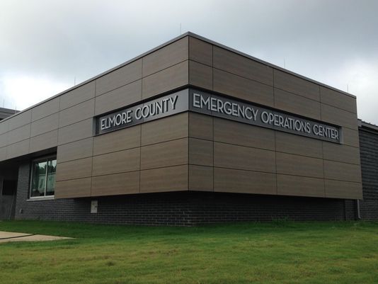 a large brick building with a sign on the side that says `` elmore county emergency operations center '' .