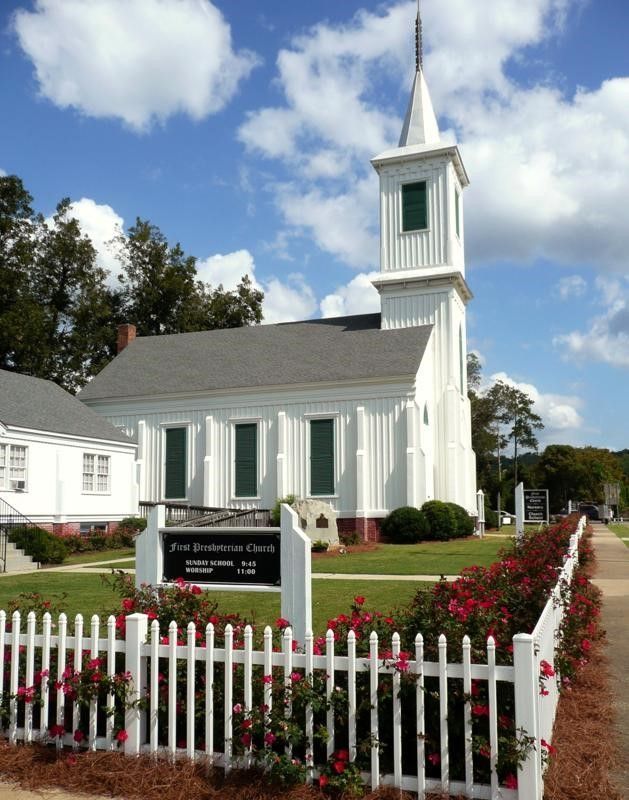 a white church with a sign that says first presbyterian church
